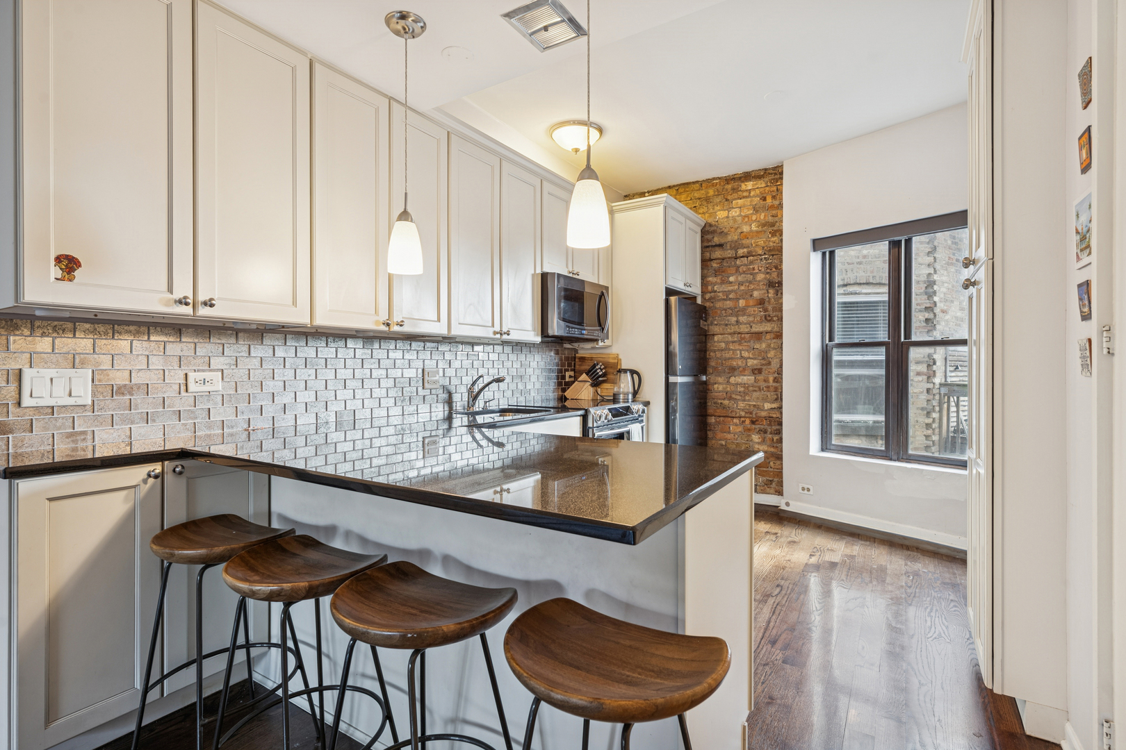 815 West Cuyler Avenue, Unit 3 Chicago, IL 60613 - Photo 6 of 16 a kitchen with granite countertop a sink and white cabinets