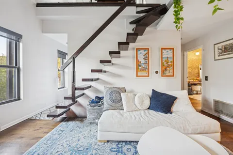 a bedroom with furniture and wooden floor