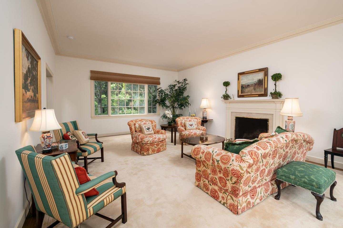 720 Eucalyptus Avenue Hillsborough, CA 94010 - Photo 12 of 48 a living room with furniture and a fireplace
