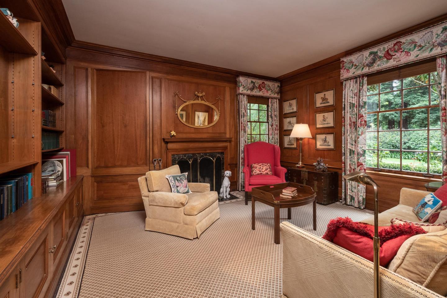 720 Eucalyptus Avenue Hillsborough, CA 94010 - Photo 13 of 48 a living room with furniture a fireplace and large windows