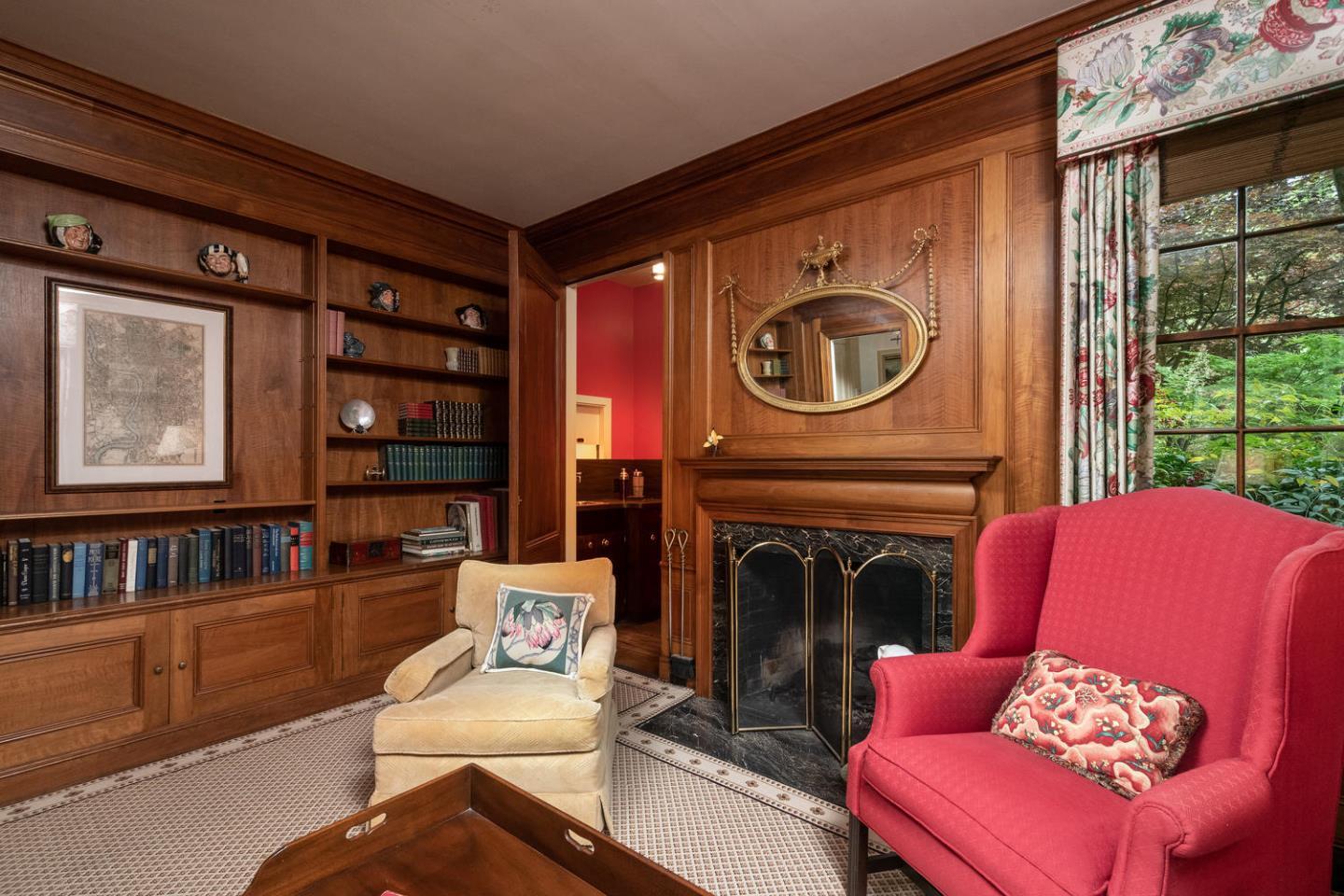 720 Eucalyptus Avenue Hillsborough, CA 94010 - Photo 14 of 48 a living room with furniture a floor to ceiling window and a fireplace