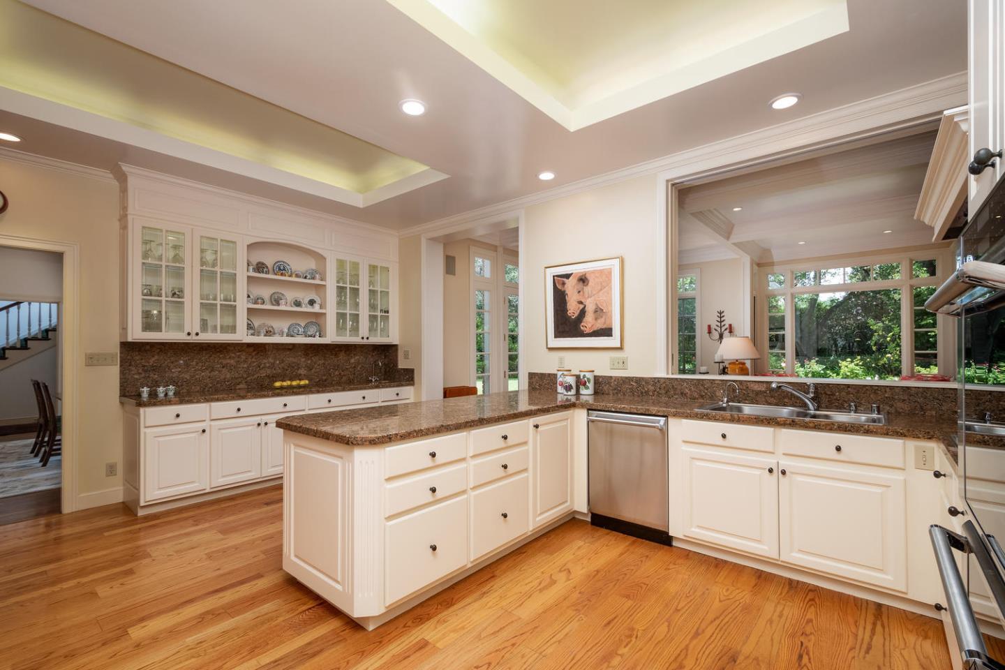 720 Eucalyptus Avenue Hillsborough, CA 94010 - Photo 20 of 48 a kitchen with stainless steel appliances granite countertop a stove and white cabinets
