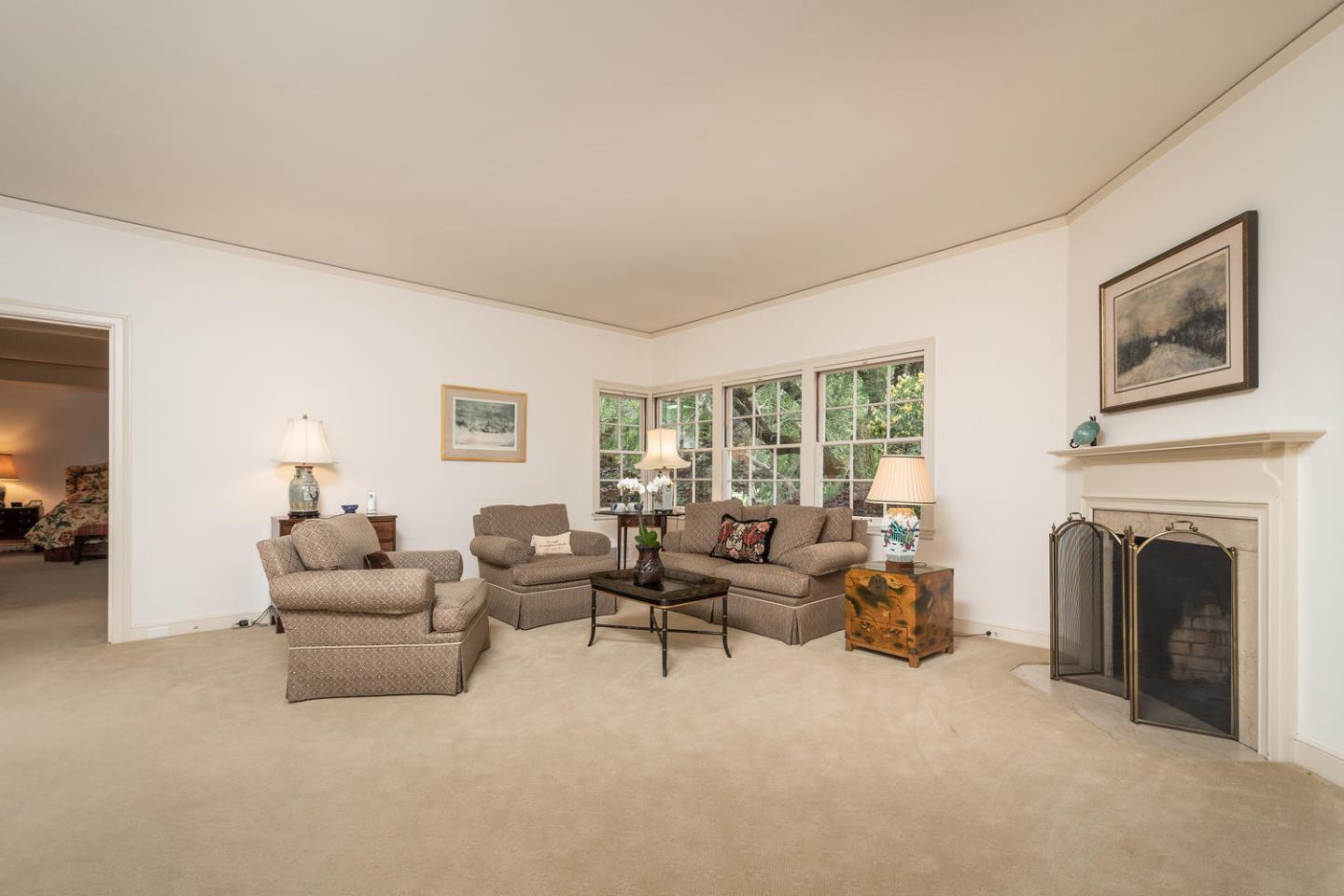 720 Eucalyptus Avenue Hillsborough, CA 94010 - Photo 24 of 48 a living room with furniture and a fireplace