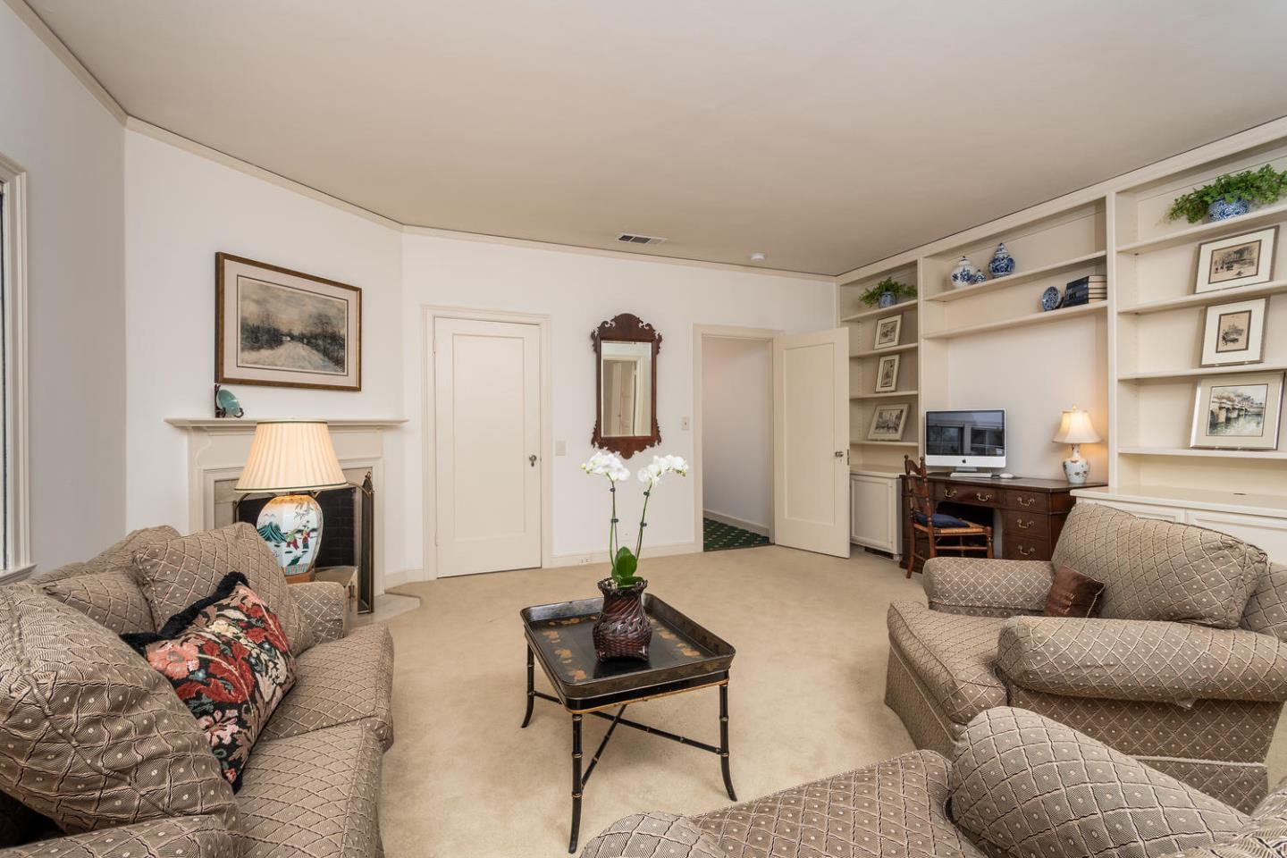 720 Eucalyptus Avenue Hillsborough, CA 94010 - Photo 25 of 48 a living room with furniture and a fireplace