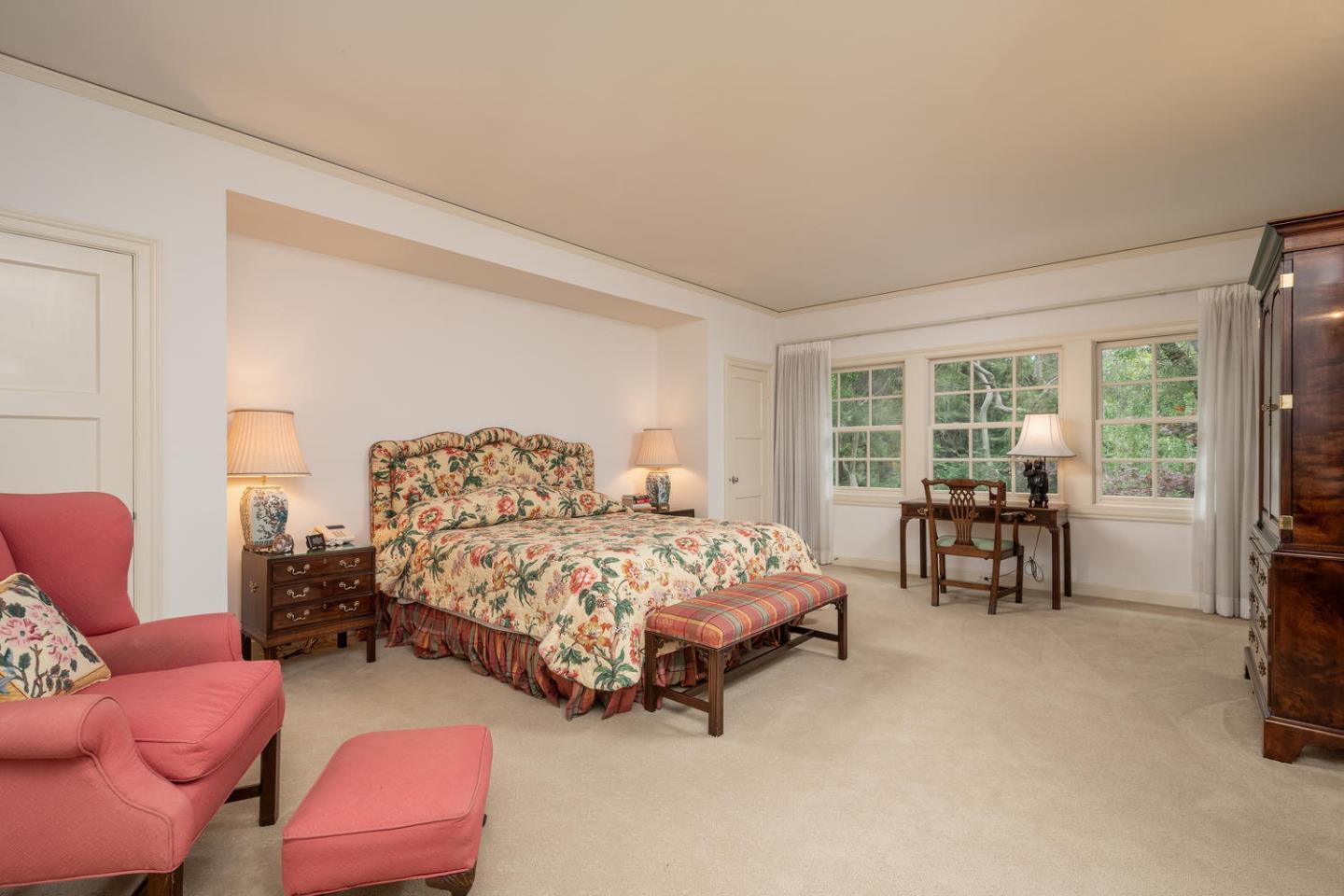 720 Eucalyptus Avenue Hillsborough, CA 94010 - Photo 26 of 48 a bedroom with bed and a large window with balcony view