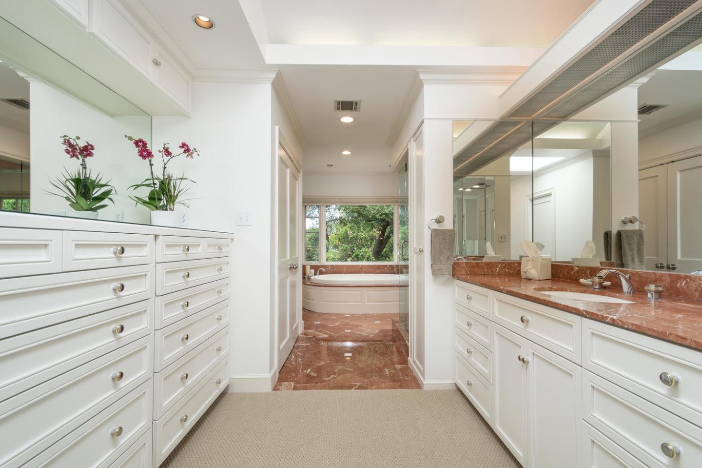 720 Eucalyptus Avenue Hillsborough, CA 94010 - Photo 28 of 48 a bathroom with a double vanity sink and a mirror
