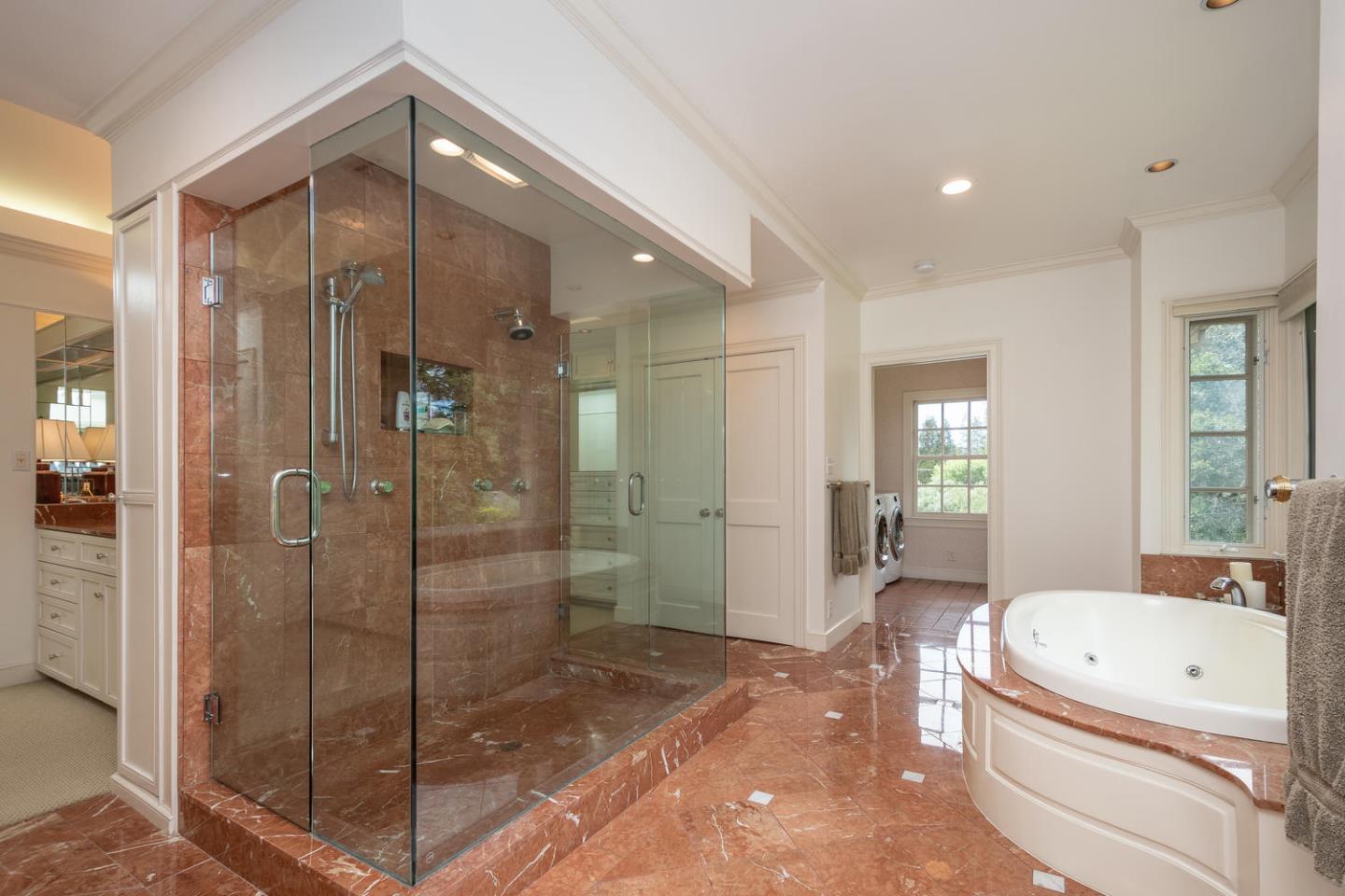 720 Eucalyptus Avenue Hillsborough, CA 94010 - Photo 29 of 48 a bathroom with a granite countertop tub shower and mirror