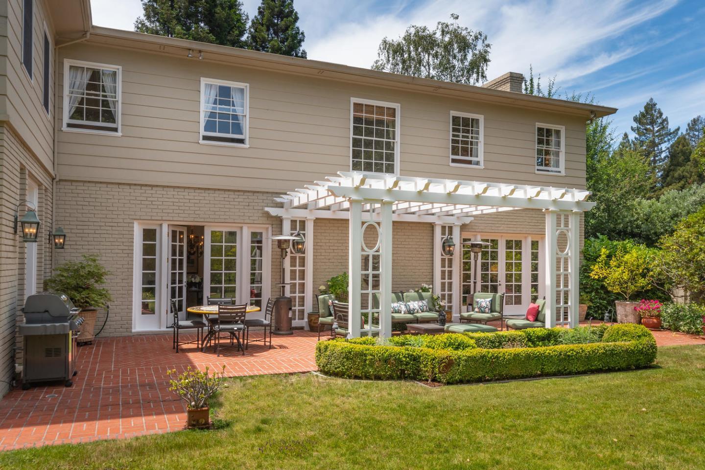 720 Eucalyptus Avenue Hillsborough, CA 94010 - Photo 39 of 48 a front view of a house with porch and garden