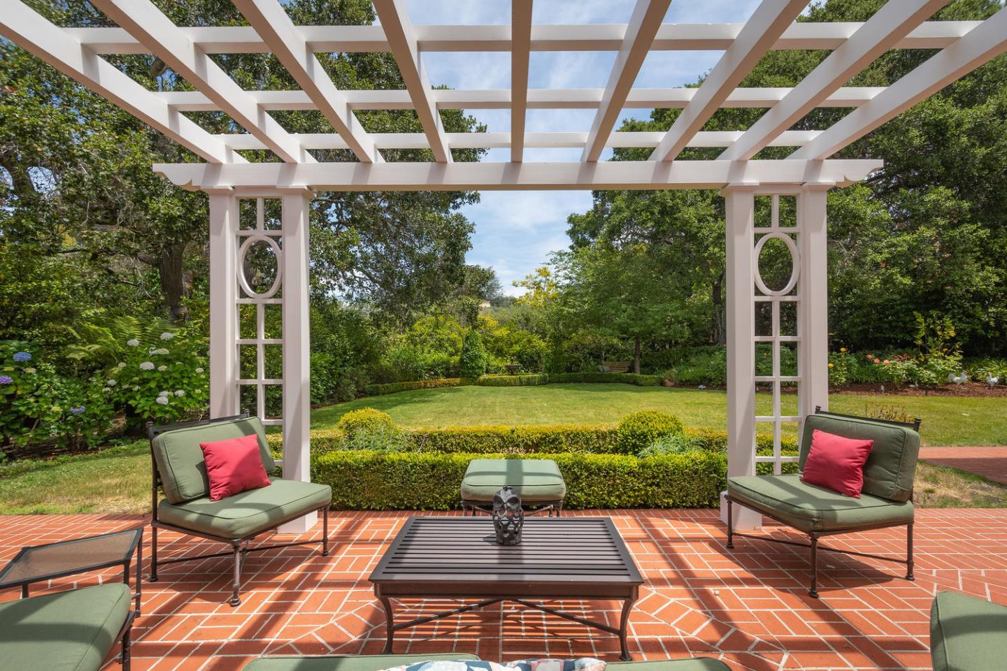 720 Eucalyptus Avenue Hillsborough, CA 94010 - Photo 40 of 48 a view of a patio with a dining table and chairs with wooden floor and fence
