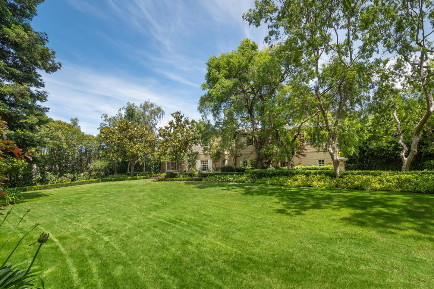 720 Eucalyptus Avenue Hillsborough, CA 94010 - Photo 4 of 48 a backyard of a house with lots of green space