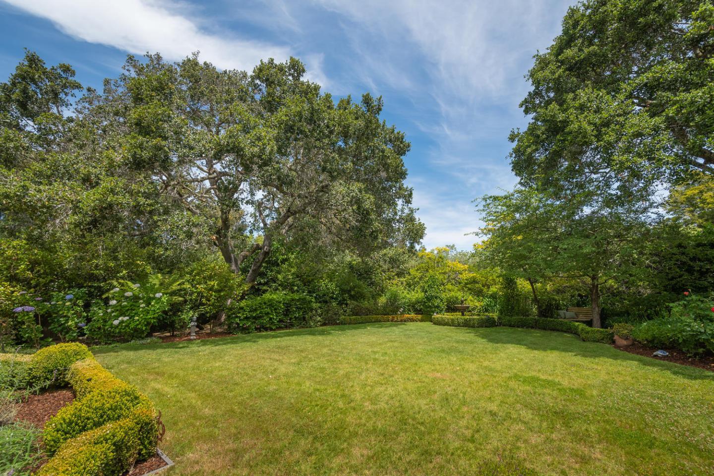 720 Eucalyptus Avenue Hillsborough, CA 94010 - Photo 44 of 48 a view of a yard with a tree