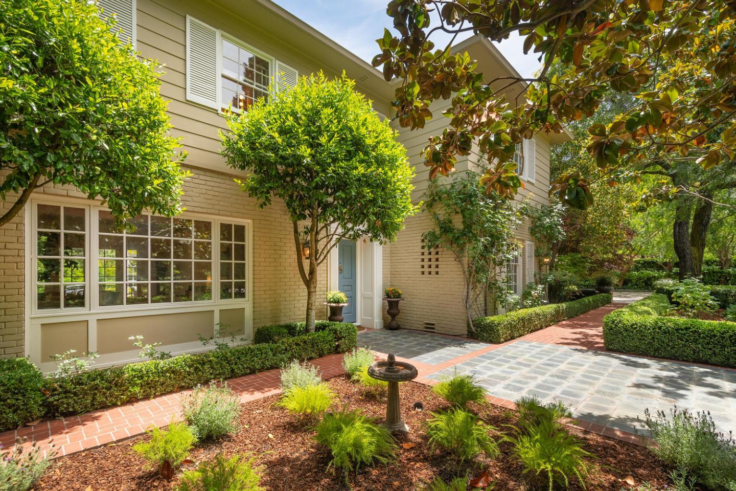 720 Eucalyptus Avenue Hillsborough, CA 94010 - Photo 7 of 48 a front view of a house with garden