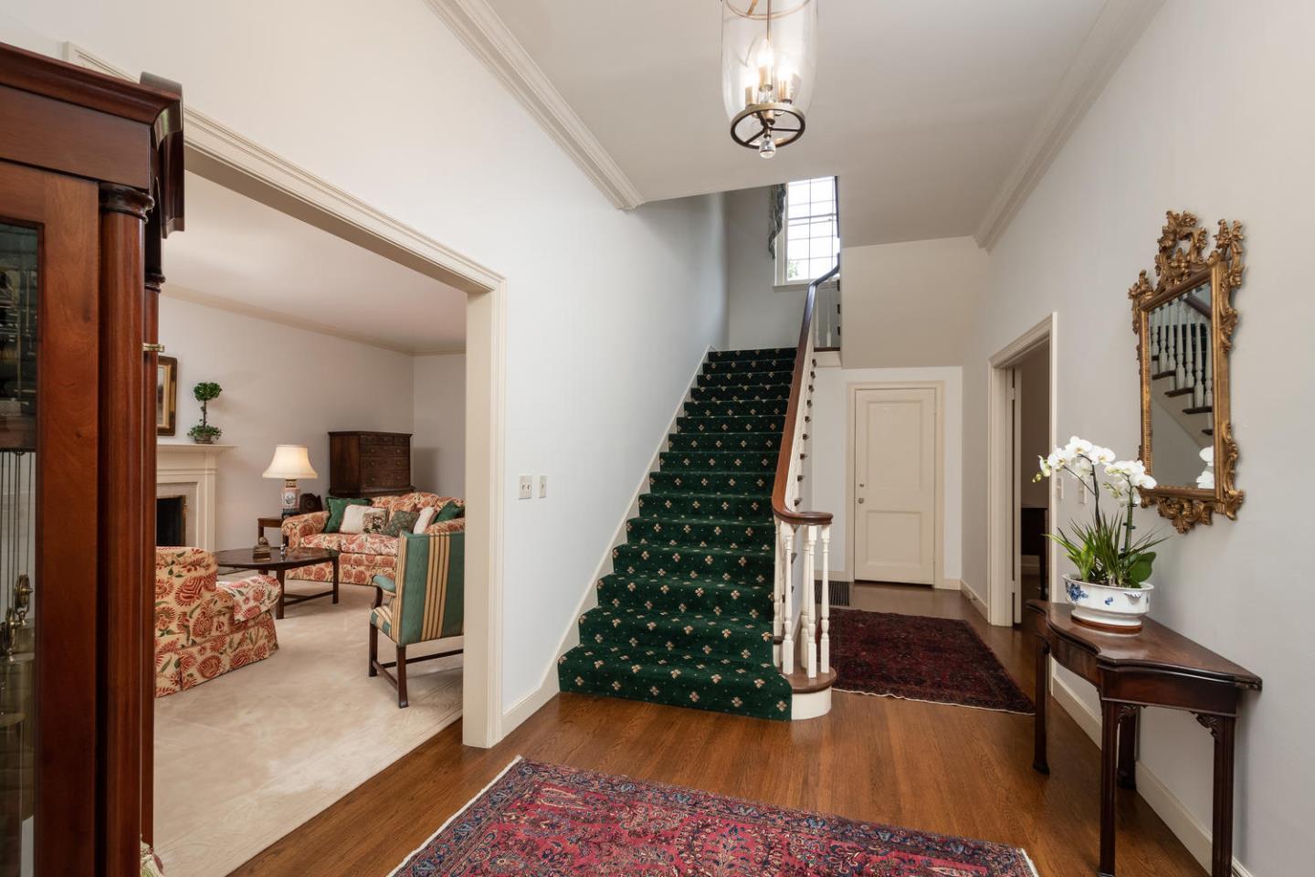 720 Eucalyptus Avenue Hillsborough, CA 94010 - Photo 10 of 48 a room with lots of white furniture and wooden floor