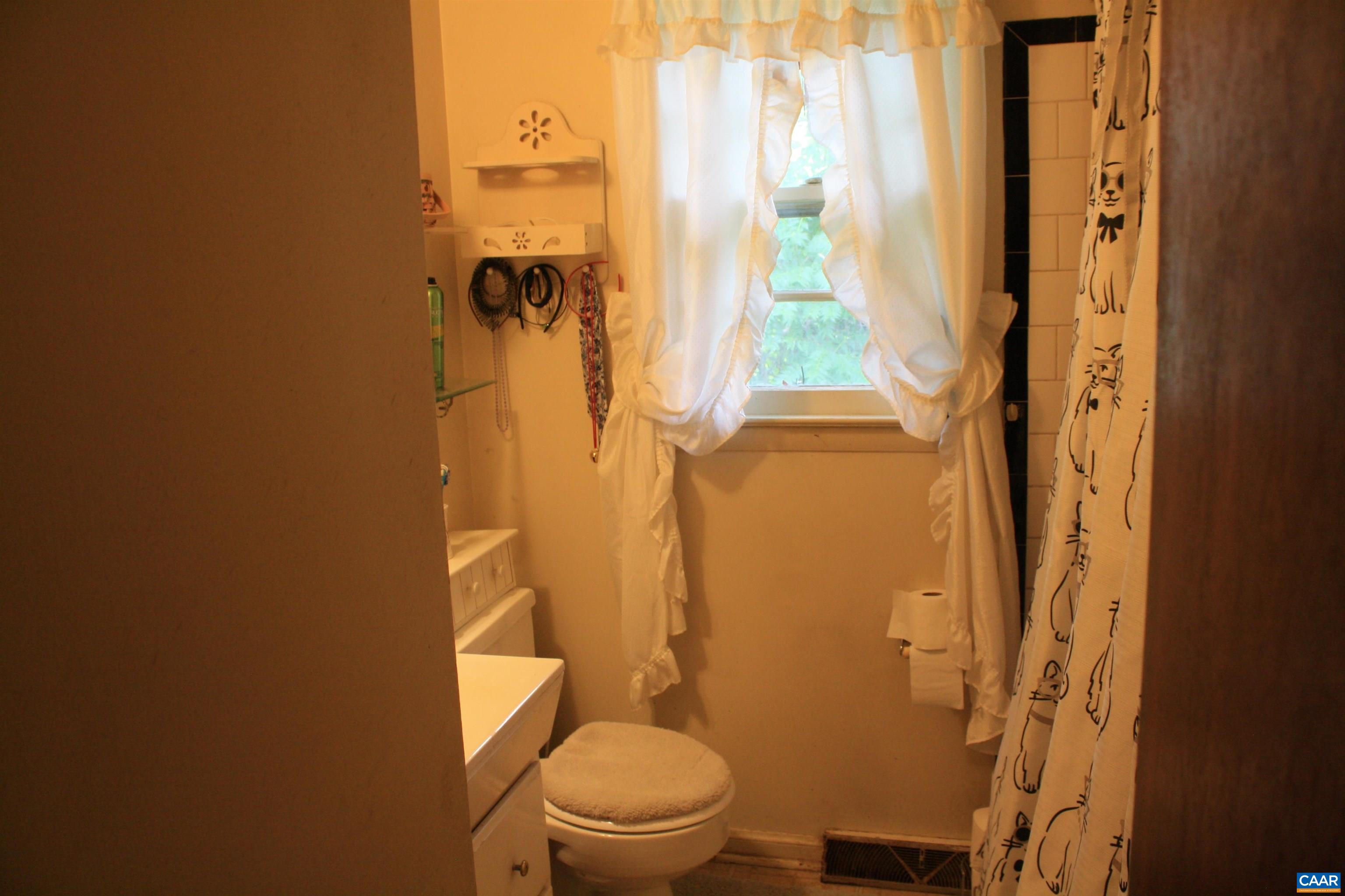 1641 Meridian Street Charlottesville, VA 22902 - Photo 11 of 21 a bathroom with a granite countertop toilet and a shower