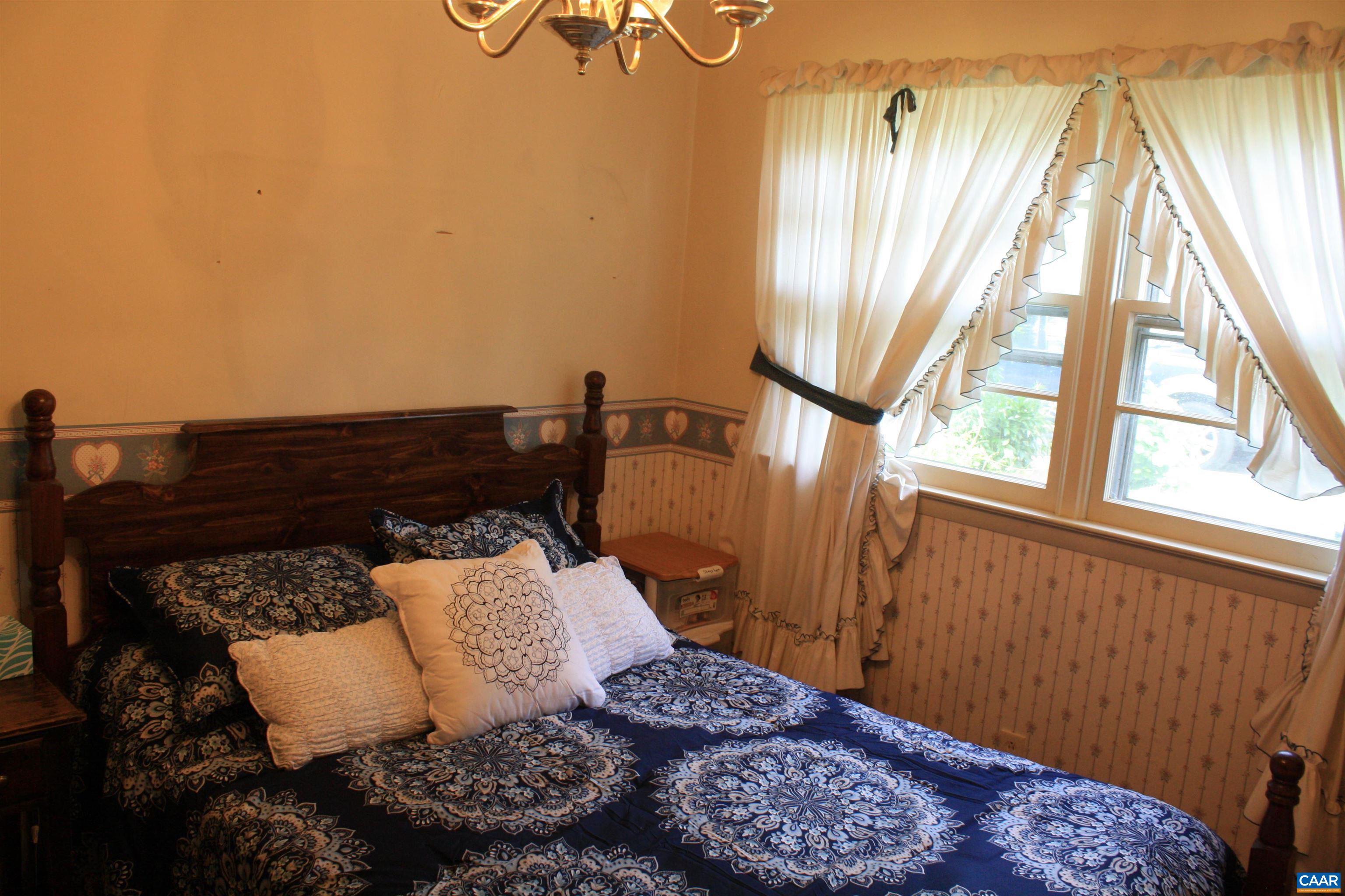 1641 Meridian Street Charlottesville, VA 22902 - Photo 7 of 21 a bed sitting in a bedroom next to a window