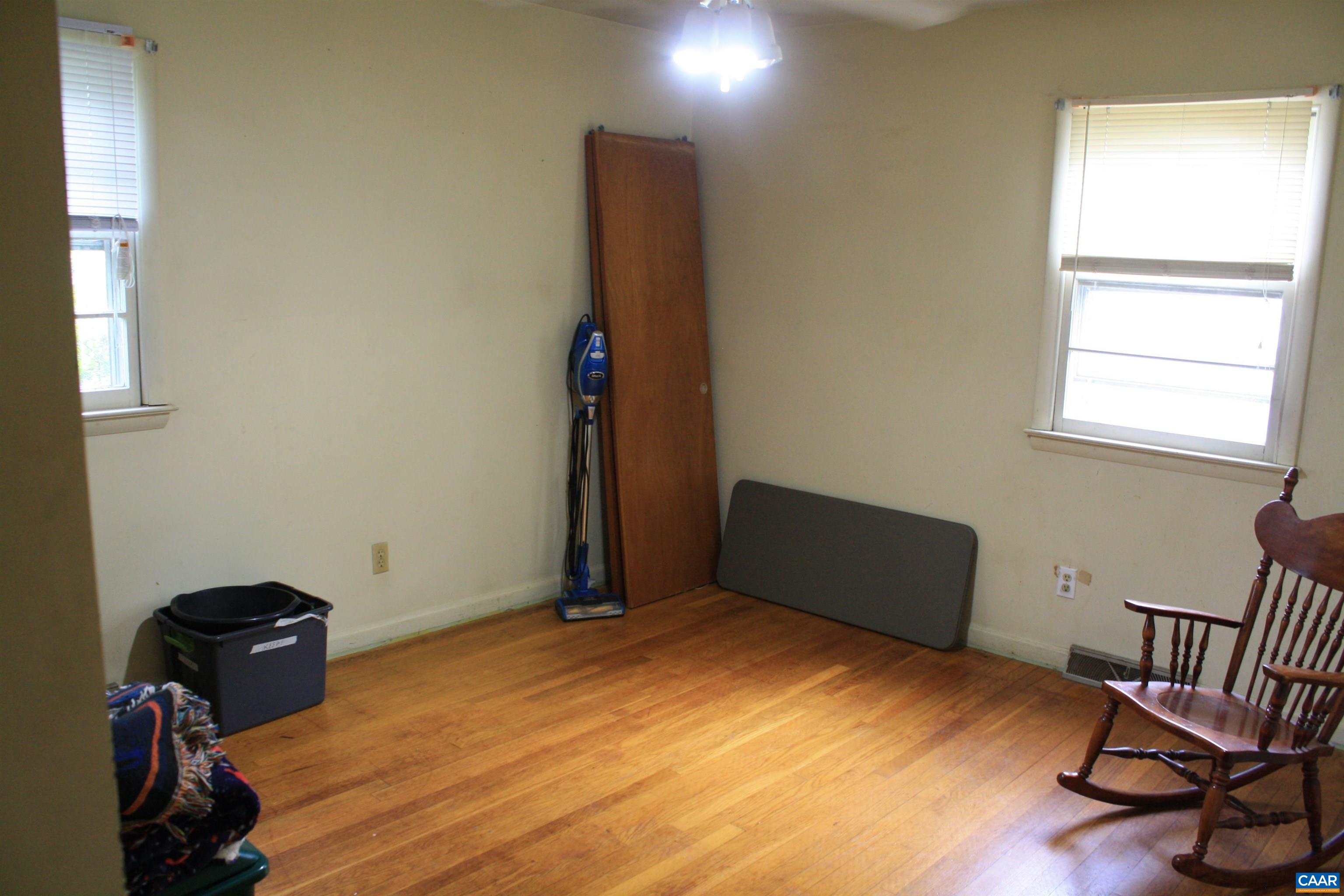 1641 Meridian Street Charlottesville, VA 22902 - Photo 8 of 21 a bedroom with a bed and wooden floor