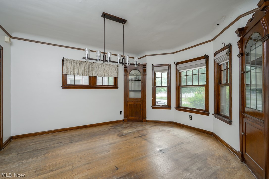 3869 Montevista Road Cleveland, OH 44121 - Photo 9 of 43 Unfurnished dining area featuring ornamental molding and hardwood / wood-style flooring