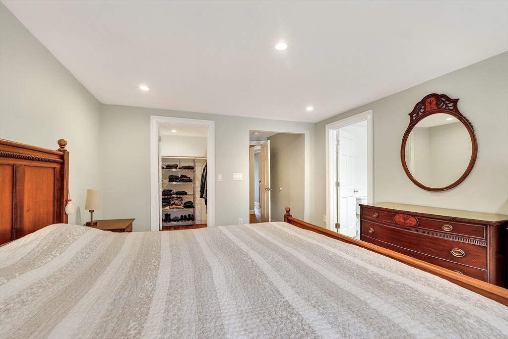 87 Payson Road Brookline, MA 02467 - Photo 23 of 41 a bedroom with a large bed and a mirror