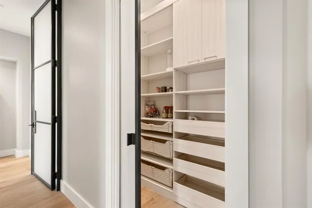 a spacious bedroom with a bed and large windows