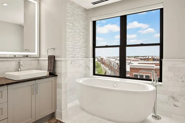 a view of a terrace with couches and lounge chairs