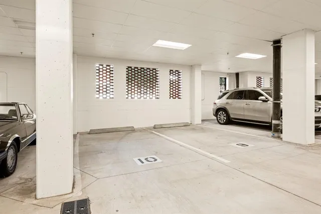 a view of a hallway with wooden floor and a fireplace