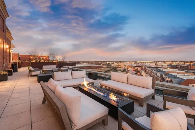 a living room with furniture a rug and a large window