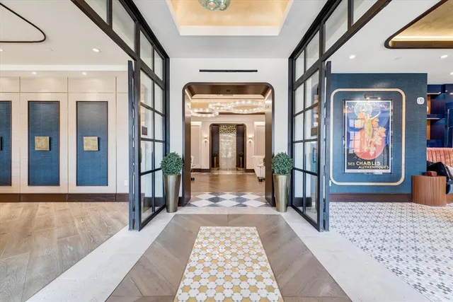 a view of a dining room with furniture a chandelier and wooden floor
