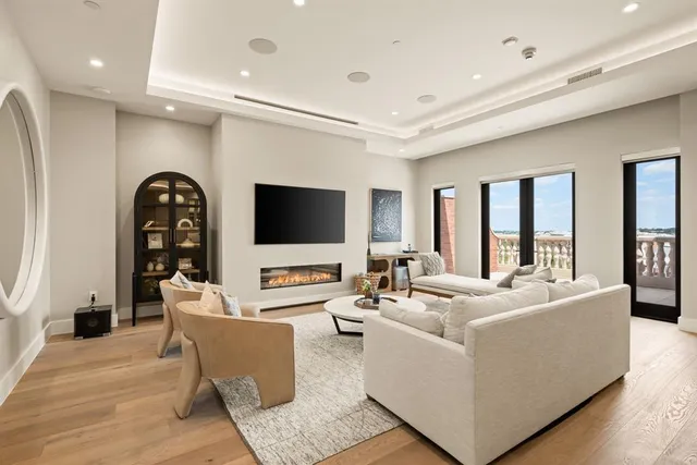 a living room with fireplace furniture and a flat screen tv