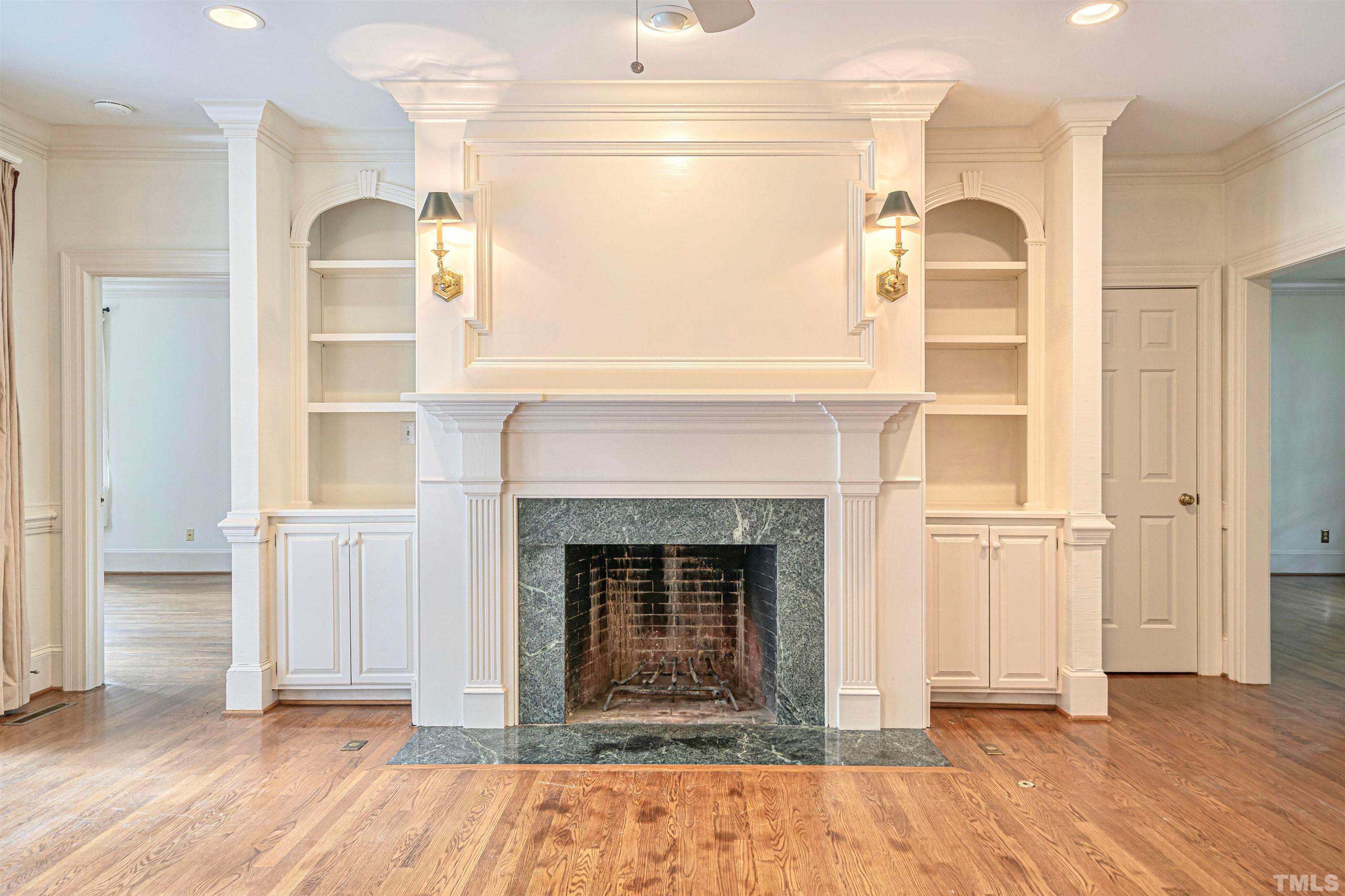 709 Runnymede Road Raleigh, NC 27607 - Photo 14 of 50 a view of a livingroom with a fireplace and wooden floor