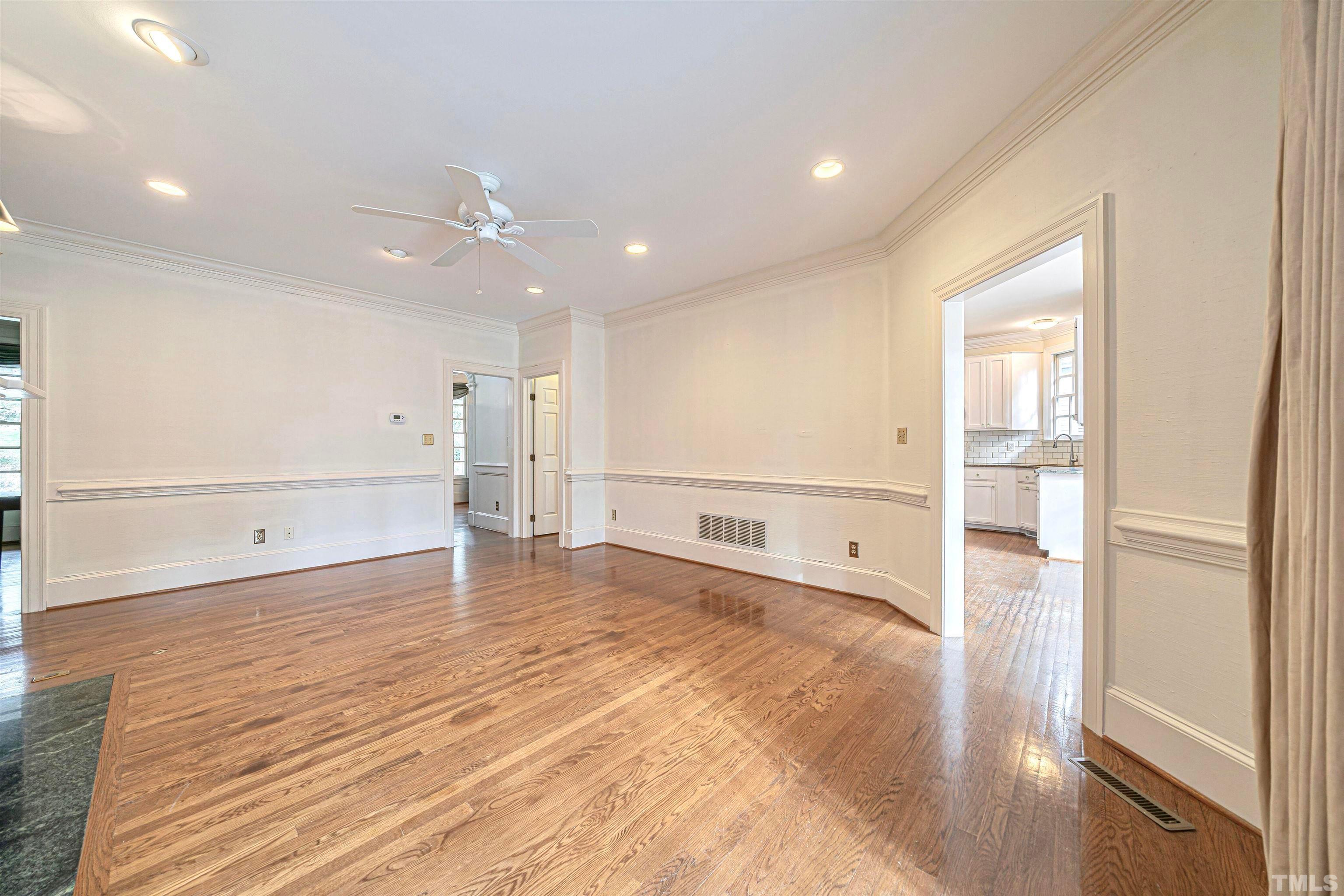 709 Runnymede Road Raleigh, NC 27607 - Photo 16 of 50 a view of an empty room with wooden floor