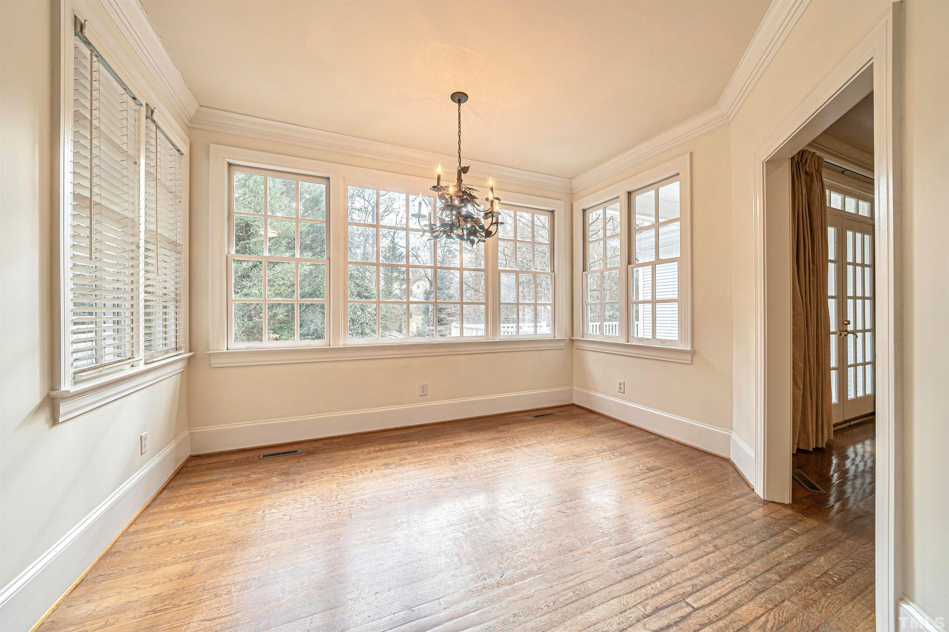 709 Runnymede Road Raleigh, NC 27607 - Photo 17 of 50 a view of an empty room with a window and wooden floor