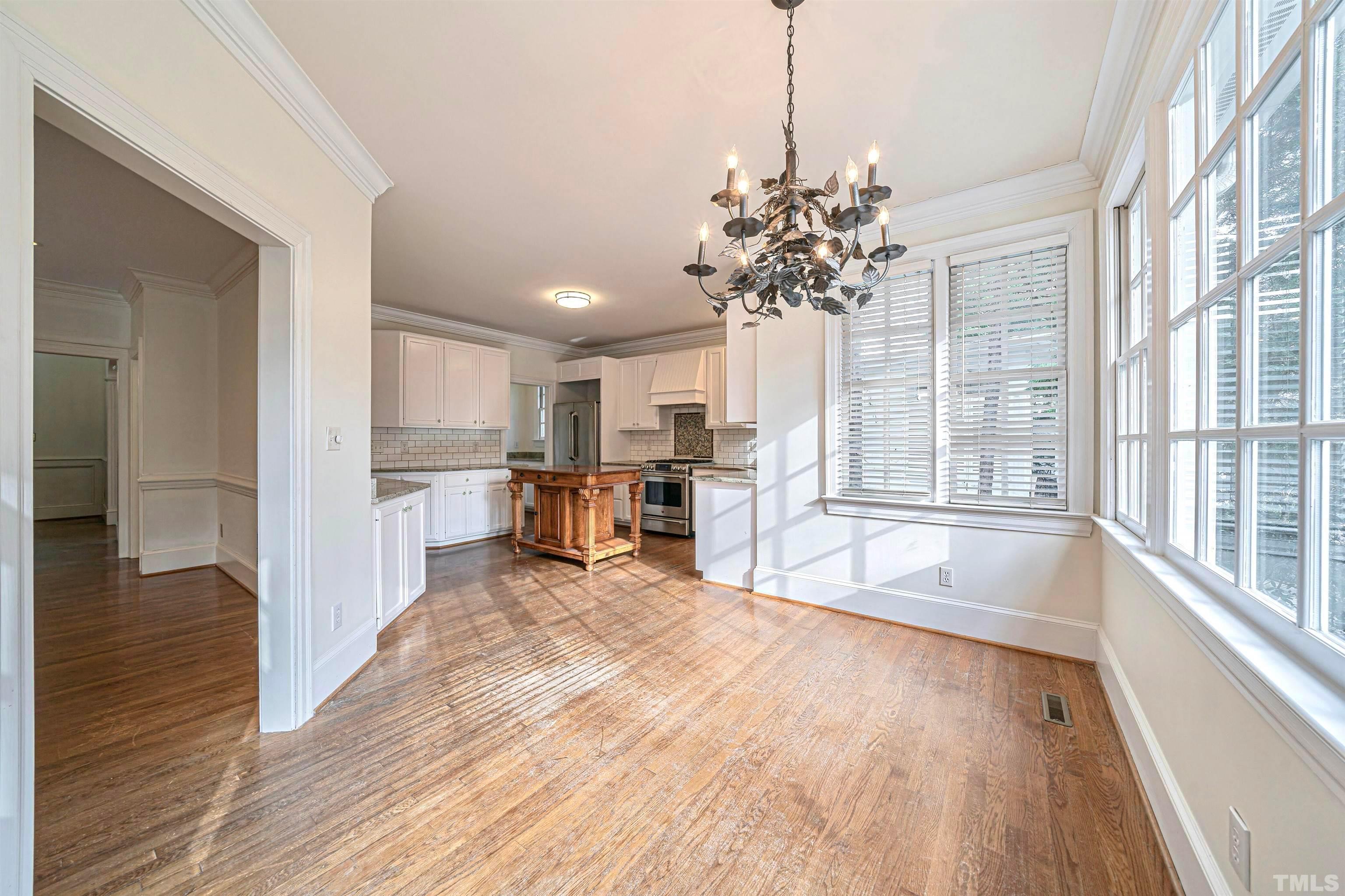 709 Runnymede Road Raleigh, NC 27607 - Photo 18 of 50 a view of a kitchen with microwave and furniture
