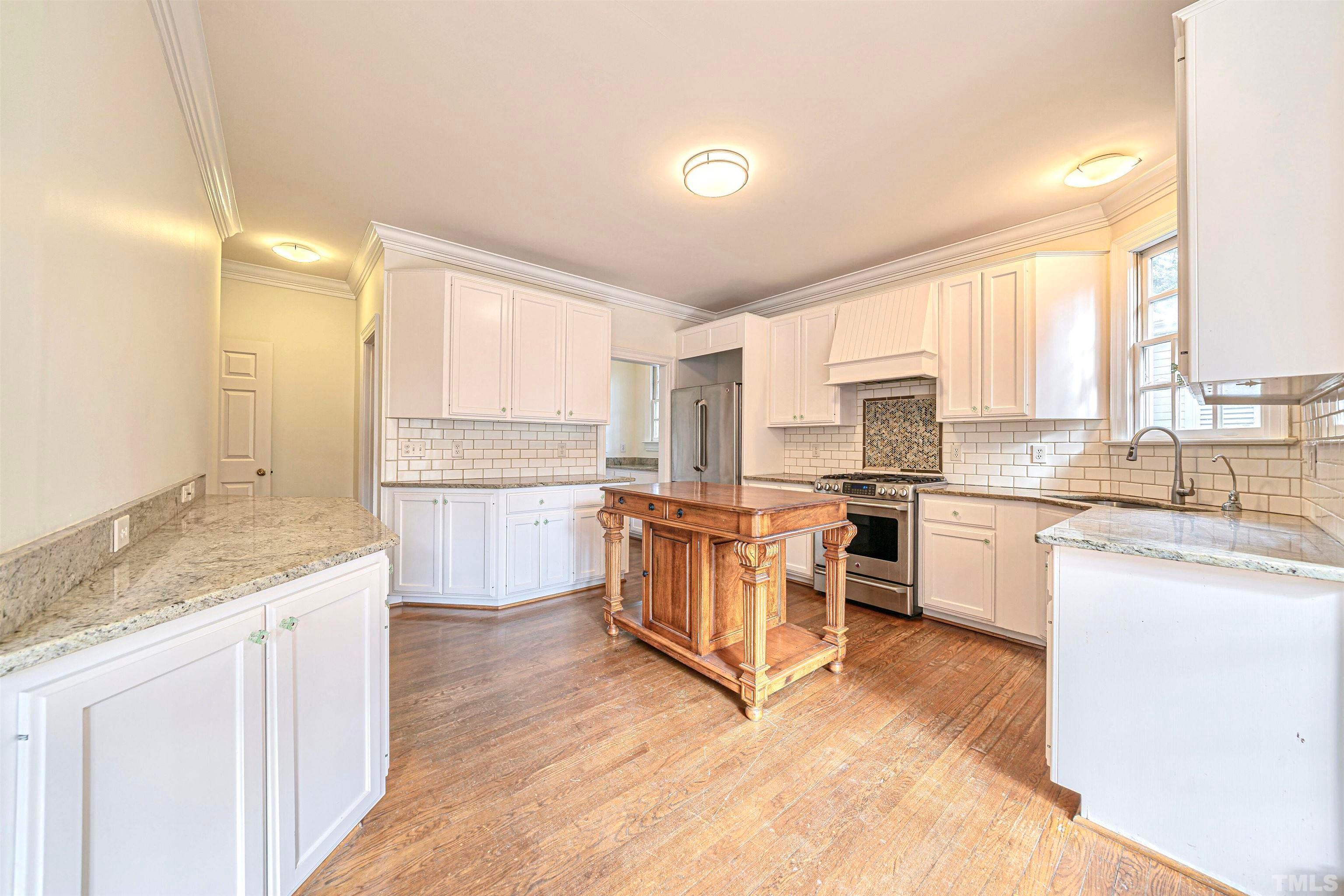 709 Runnymede Road Raleigh, NC 27607 - Photo 19 of 50 a kitchen with a sink window and cabinets