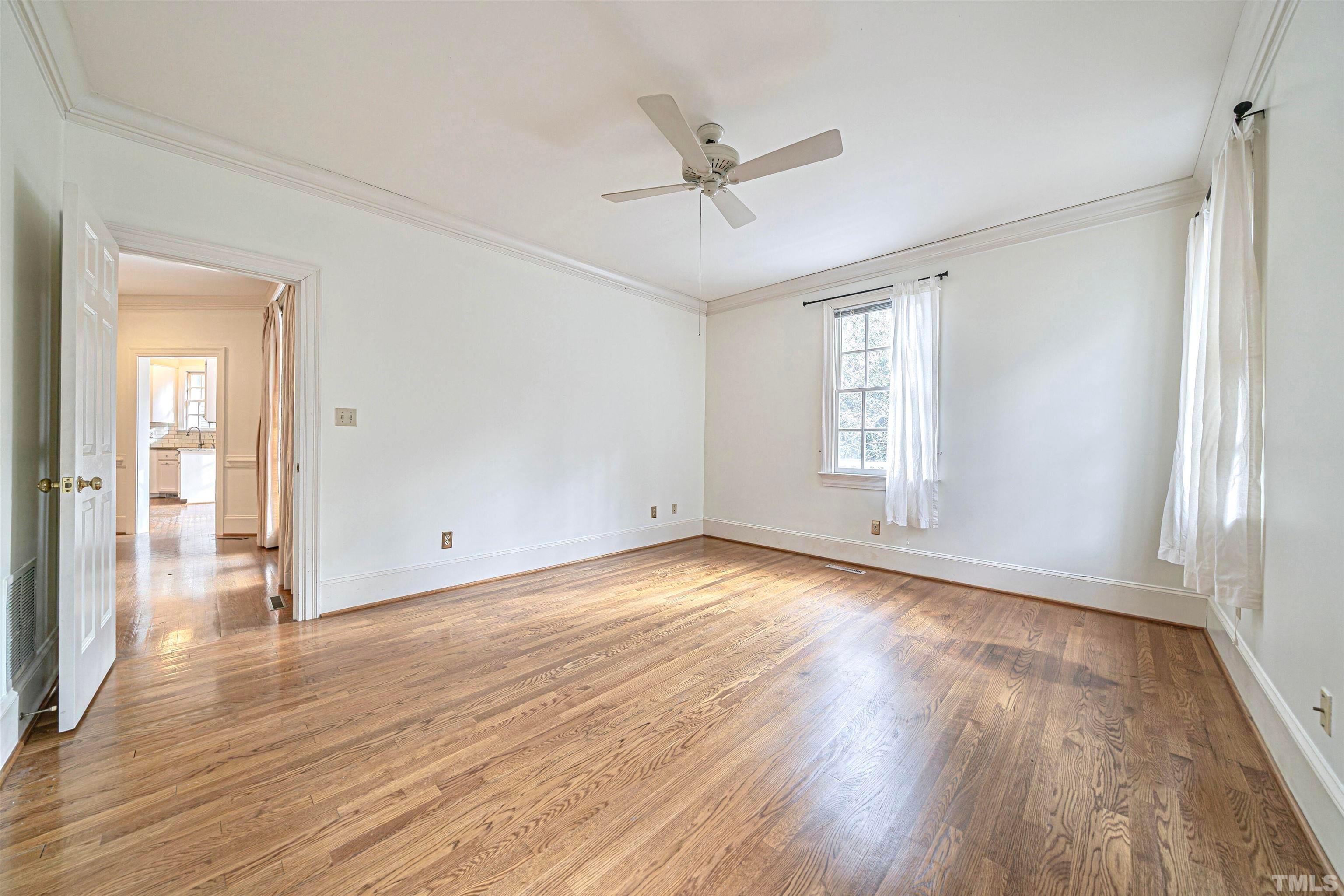 709 Runnymede Road Raleigh, NC 27607 - Photo 24 of 50 a view of empty room with wooden floor and fan
