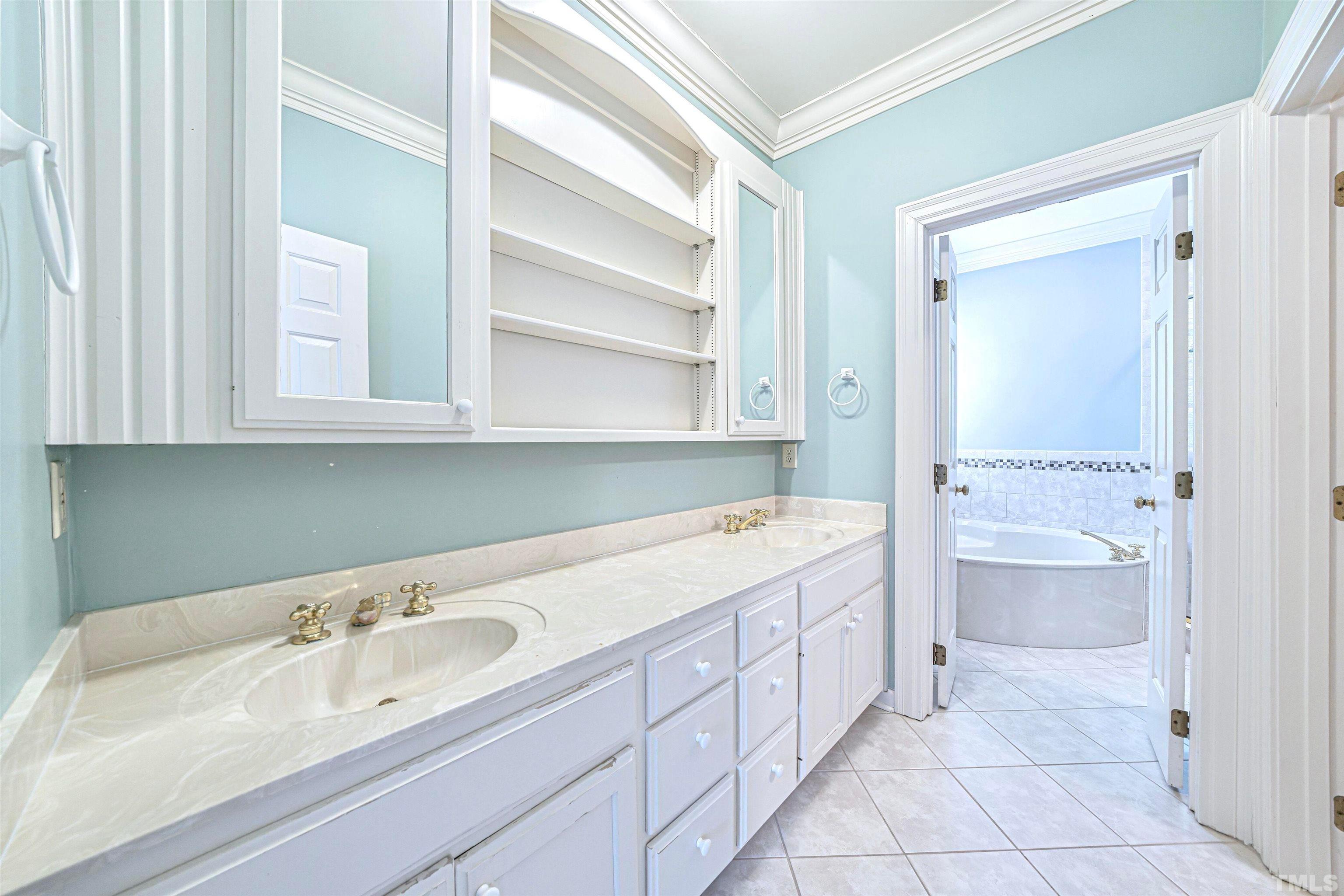 709 Runnymede Road Raleigh, NC 27607 - Photo 26 of 50 a spacious bathroom with a granite countertop sink and a mirror