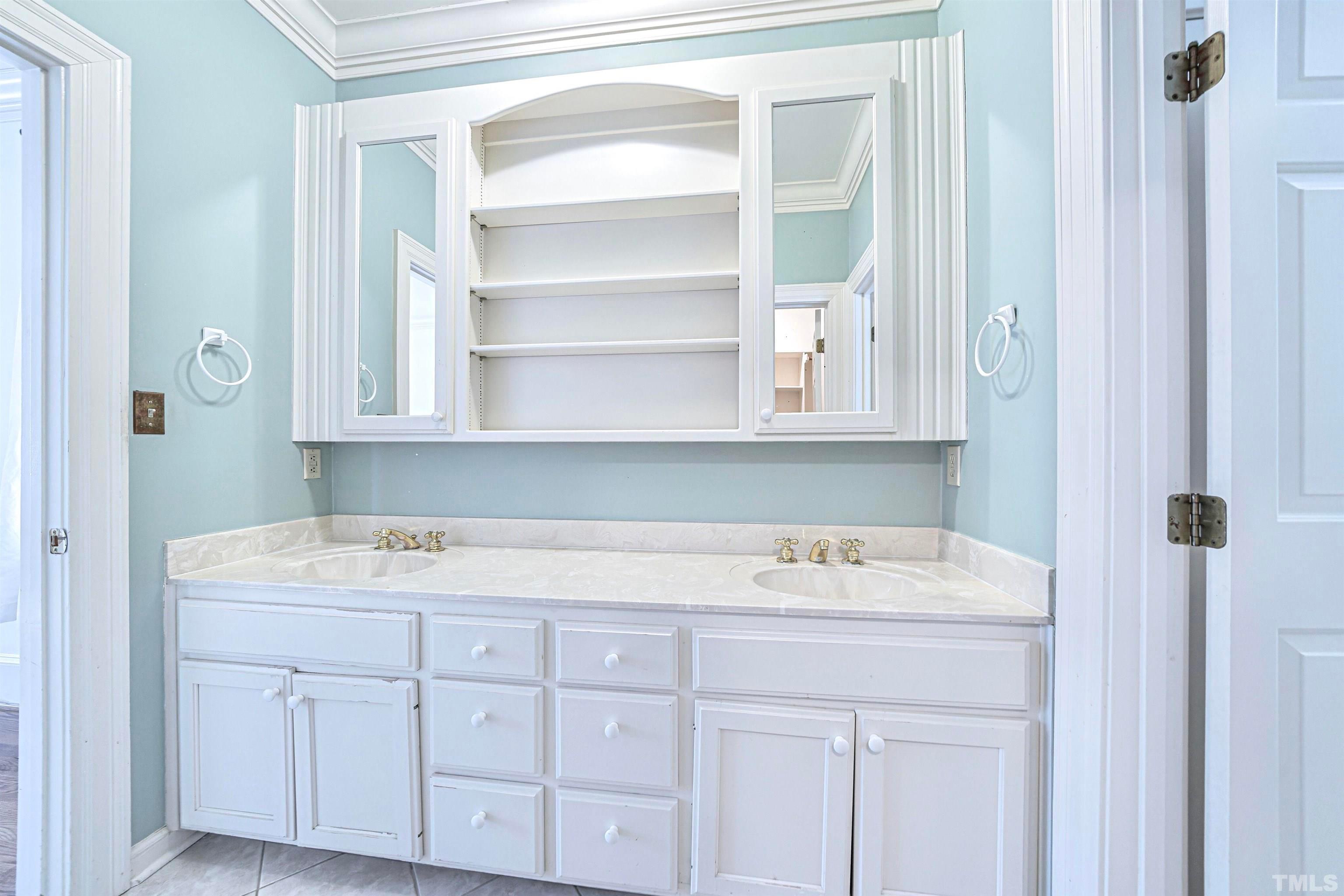 709 Runnymede Road Raleigh, NC 27607 - Photo 27 of 50 a bathroom with a sink and a mirror