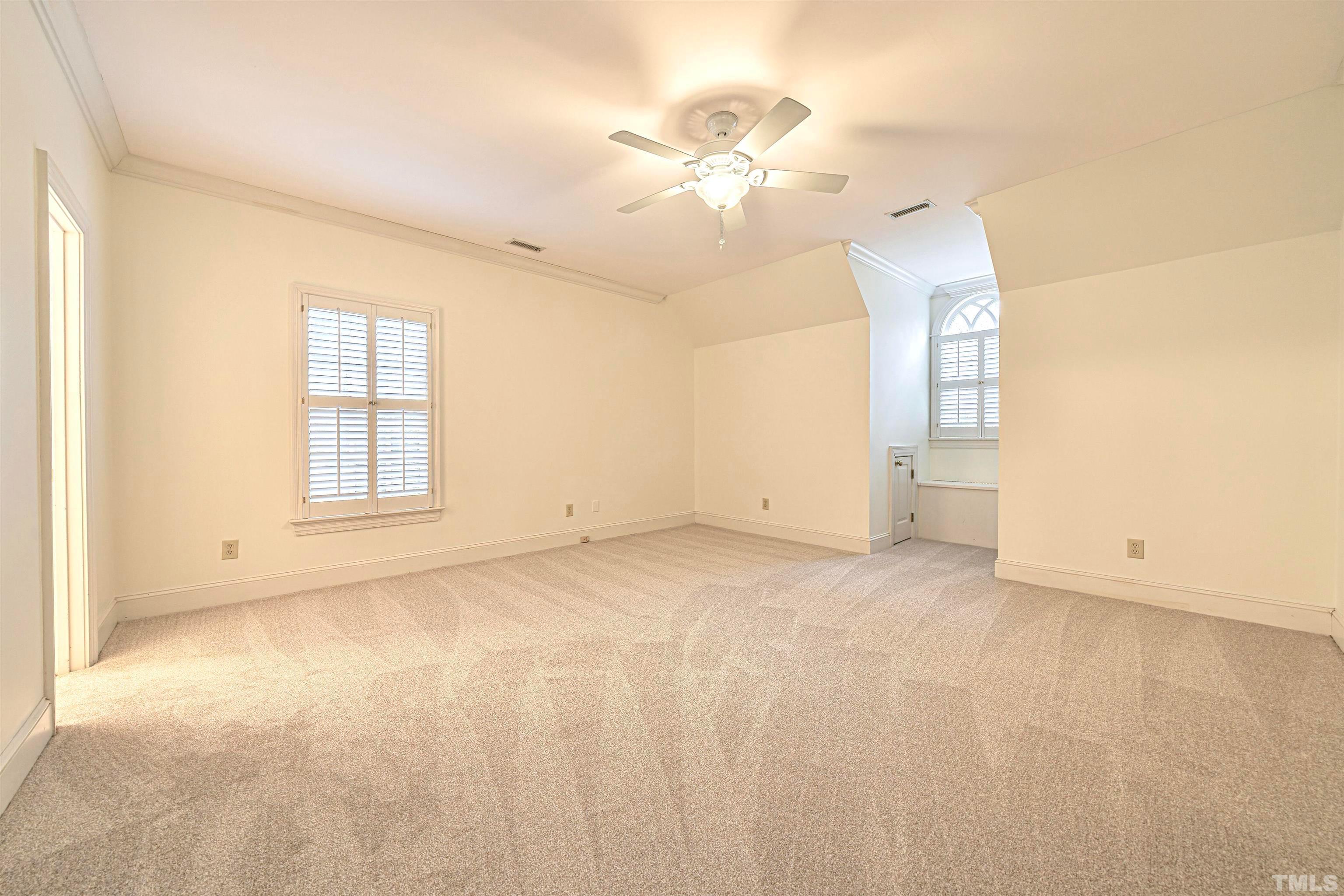 709 Runnymede Road Raleigh, NC 27607 - Photo 34 of 50 an empty room with a chandelier fan and window