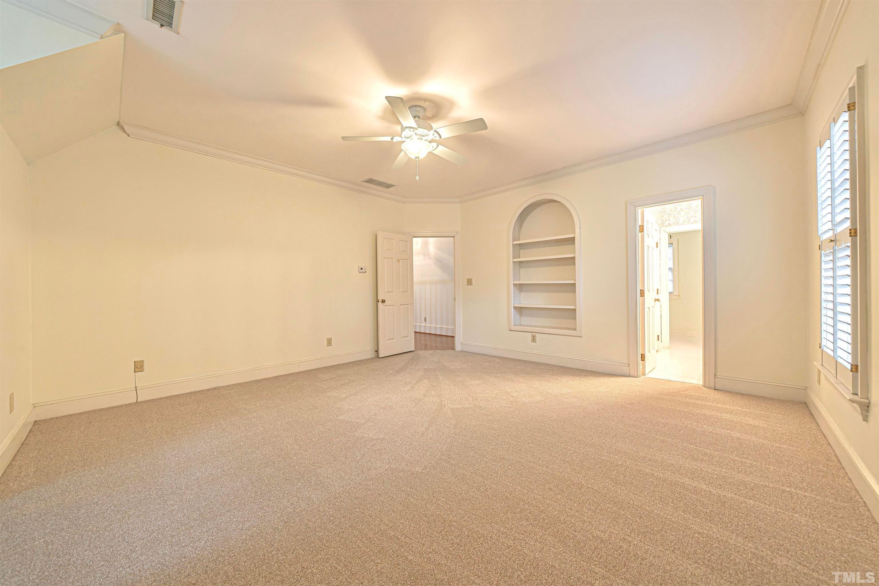 709 Runnymede Road Raleigh, NC 27607 - Photo 35 of 50 an empty room with chandelier fan and windows