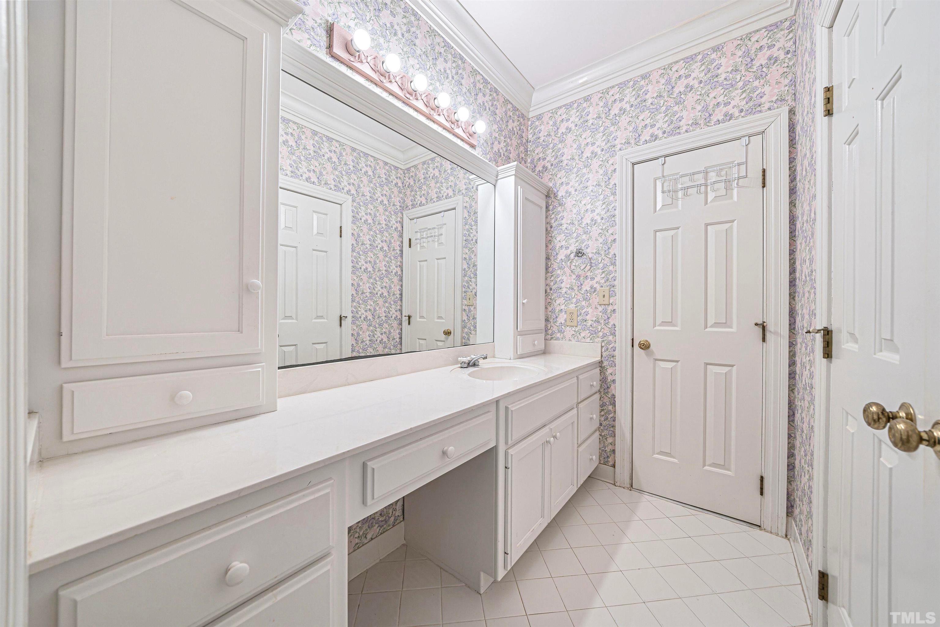 709 Runnymede Road Raleigh, NC 27607 - Photo 37 of 50 a bathroom with a sink and a mirror