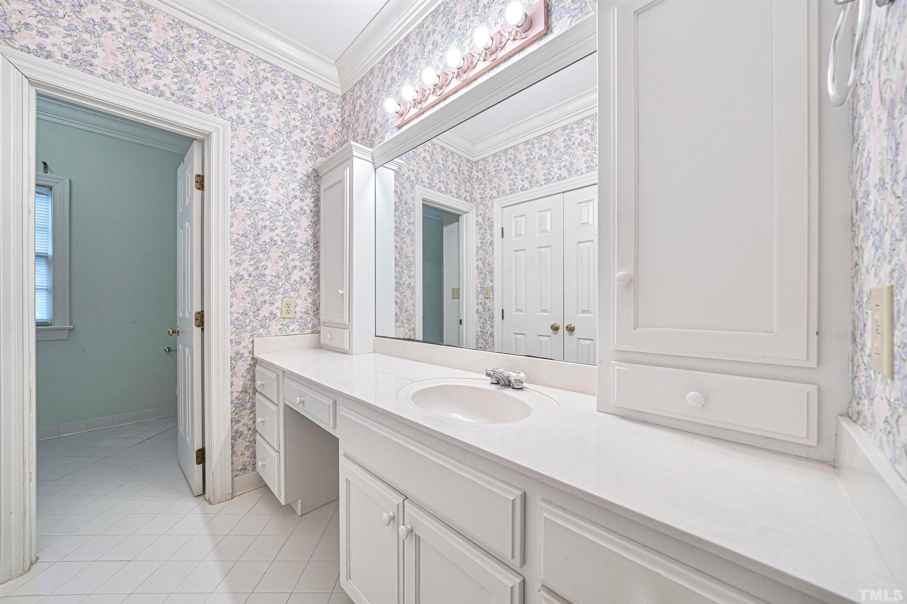 709 Runnymede Road Raleigh, NC 27607 - Photo 39 of 50 a bathroom with a sink and a mirror