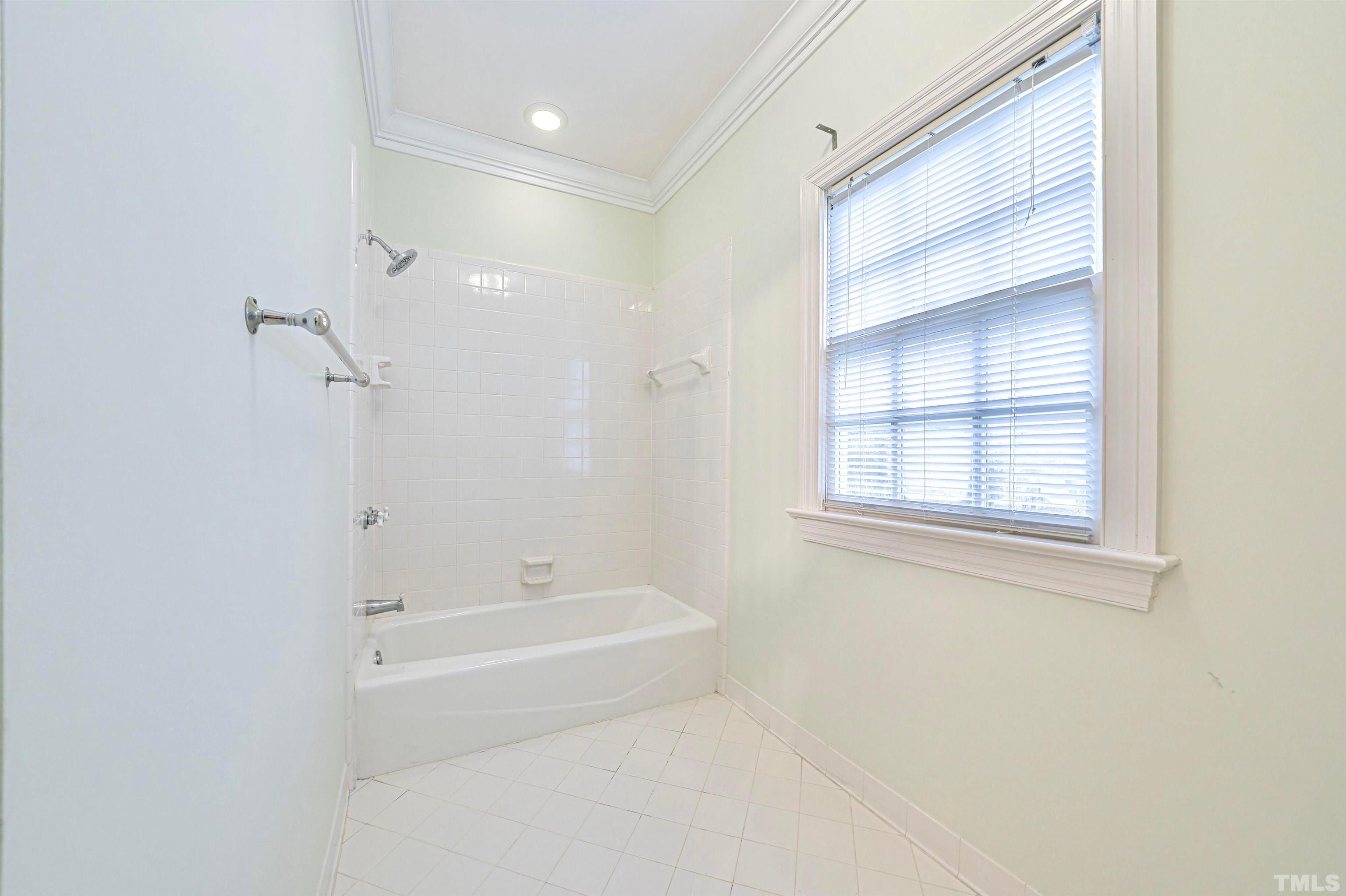 709 Runnymede Road Raleigh, NC 27607 - Photo 40 of 50 a bathroom with a bathtub and a shower