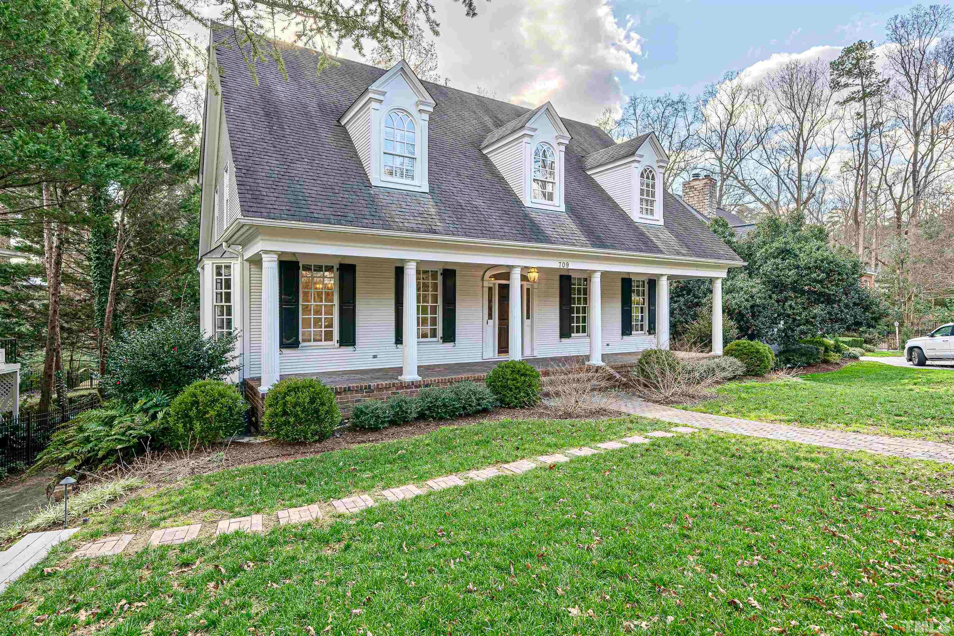 709 Runnymede Road Raleigh, NC 27607 - Photo 4 of 50 front view of a house with a yard