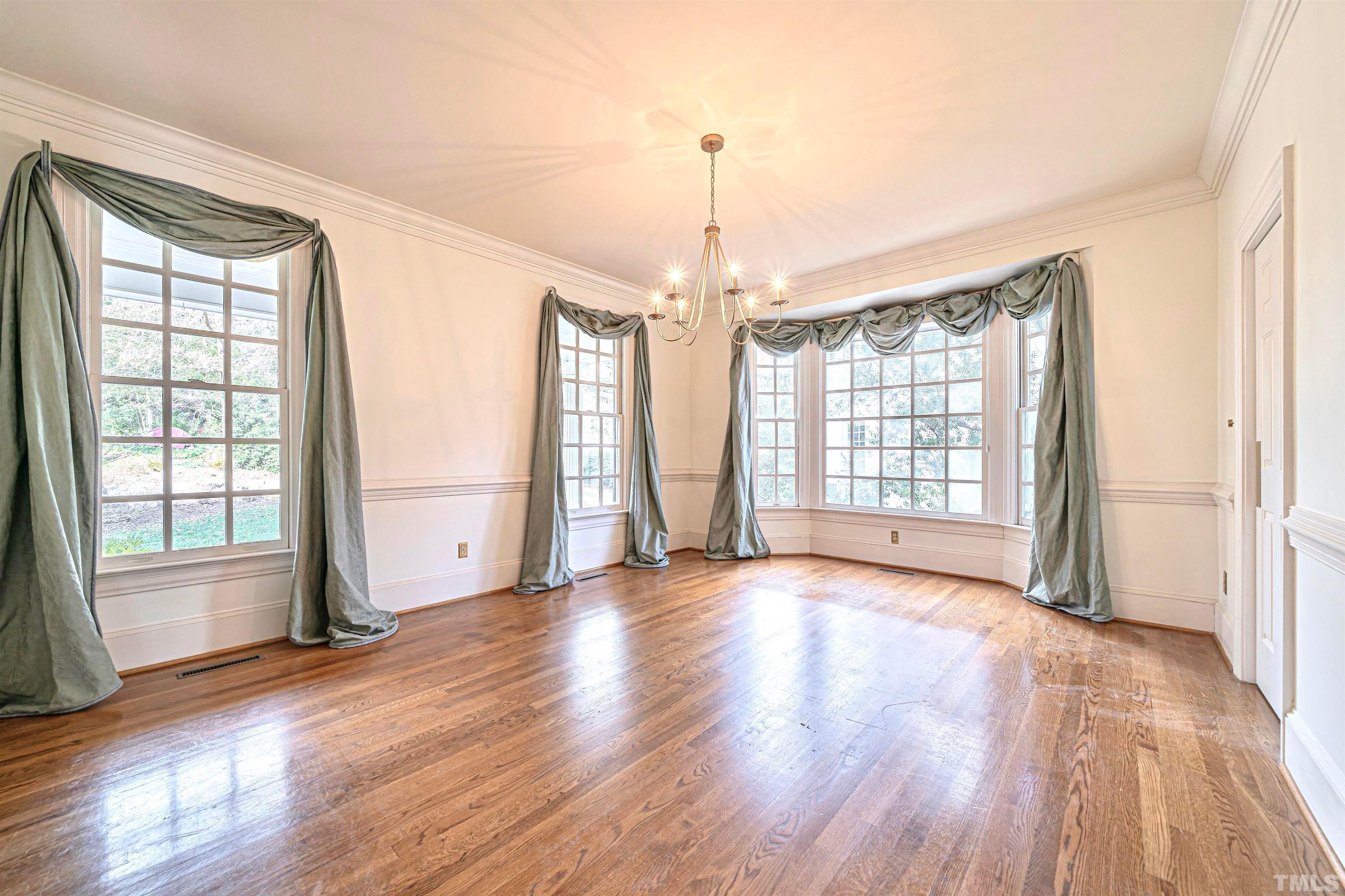 709 Runnymede Road Raleigh, NC 27607 - Photo 10 of 50 a view of an empty room with glass door and wooden floor