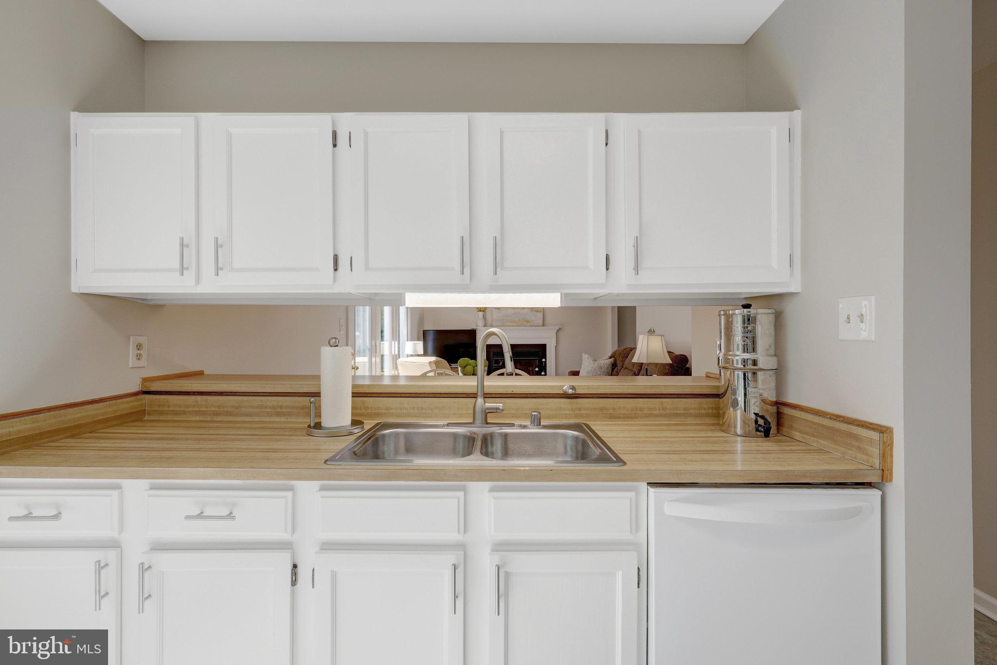 73 McPherson Circle Sterling, VA 20165 - Photo 19 of 74 a kitchen with stainless steel appliances granite countertop a sink a stove and white cabinets