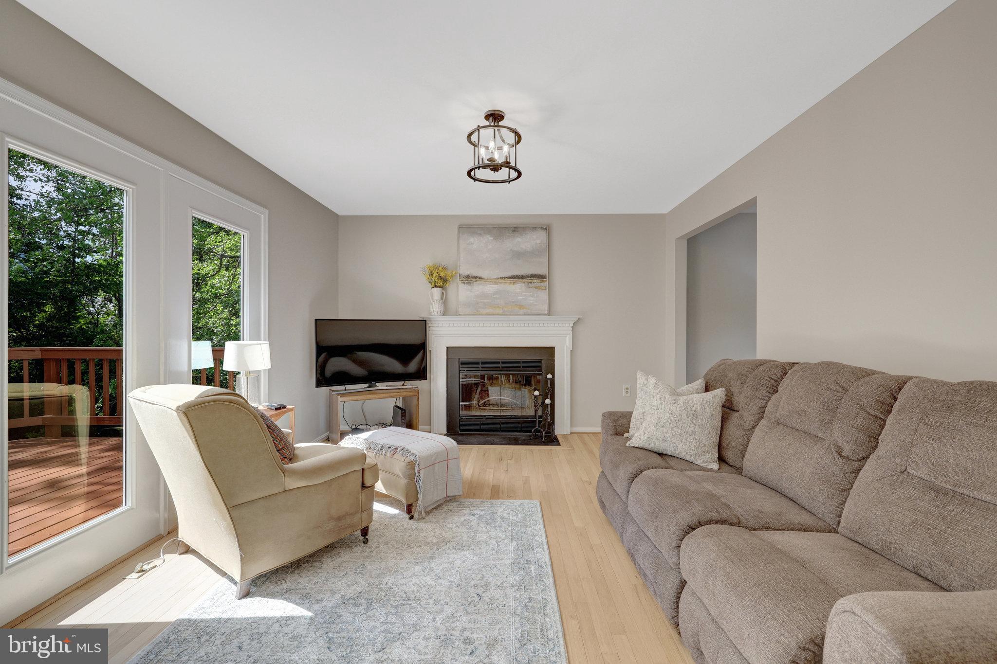 73 McPherson Circle Sterling, VA 20165 - Photo 25 of 74 a living room with furniture a flat screen tv and a fireplace