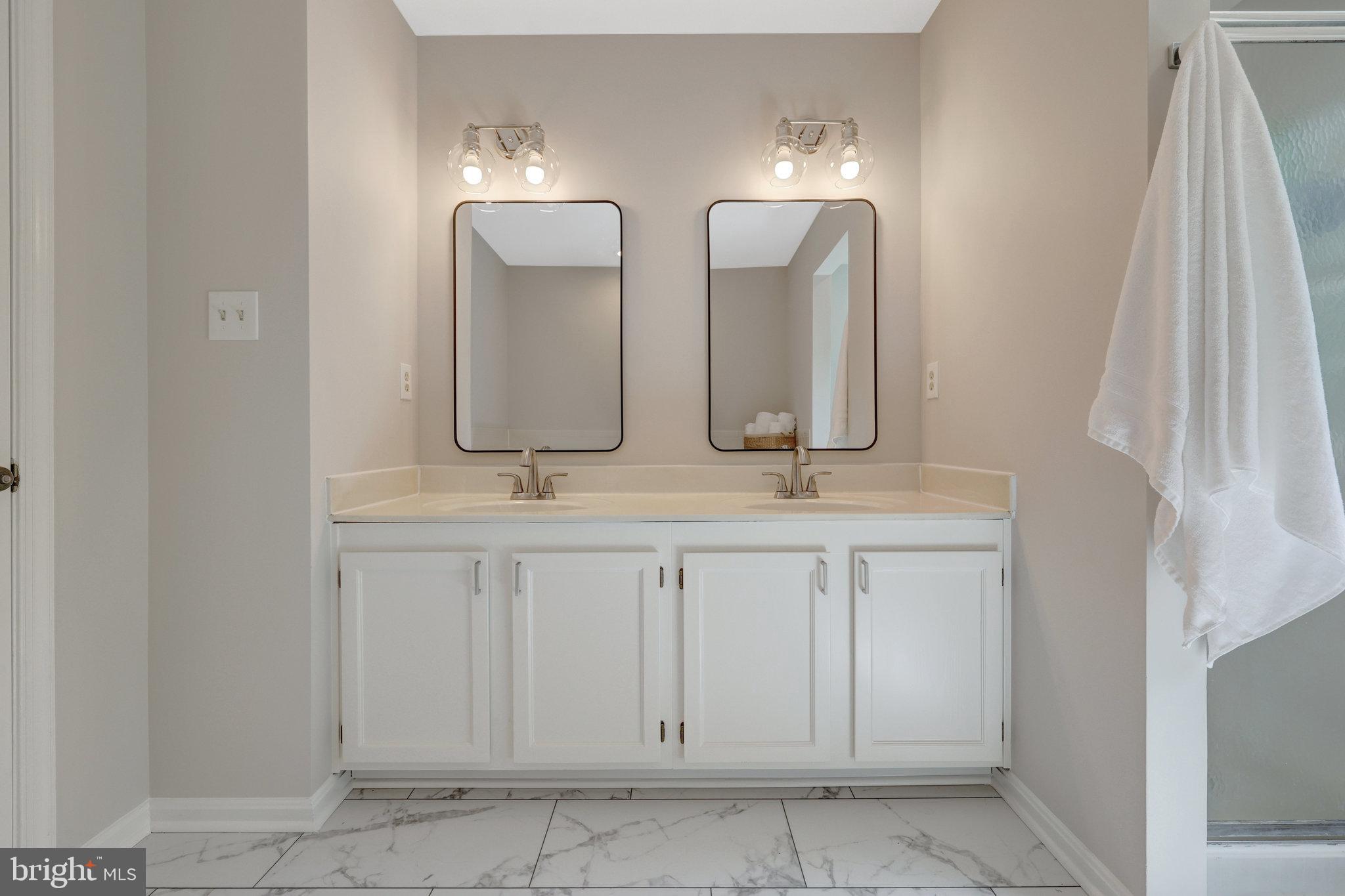 73 McPherson Circle Sterling, VA 20165 - Photo 35 of 74 a bathroom with double vanity sinks and a mirror