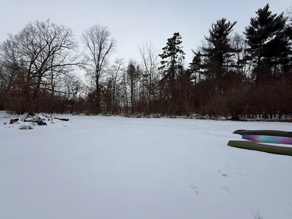 a view of a house with a snow in the yard