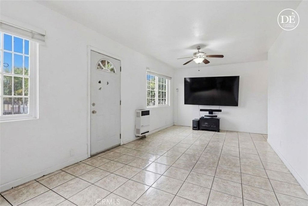 440 West Cherry Street Compton, CA 90222 - Photo 16 of 28 a view of a livingroom with a flat screen tv wooden floor and windows
