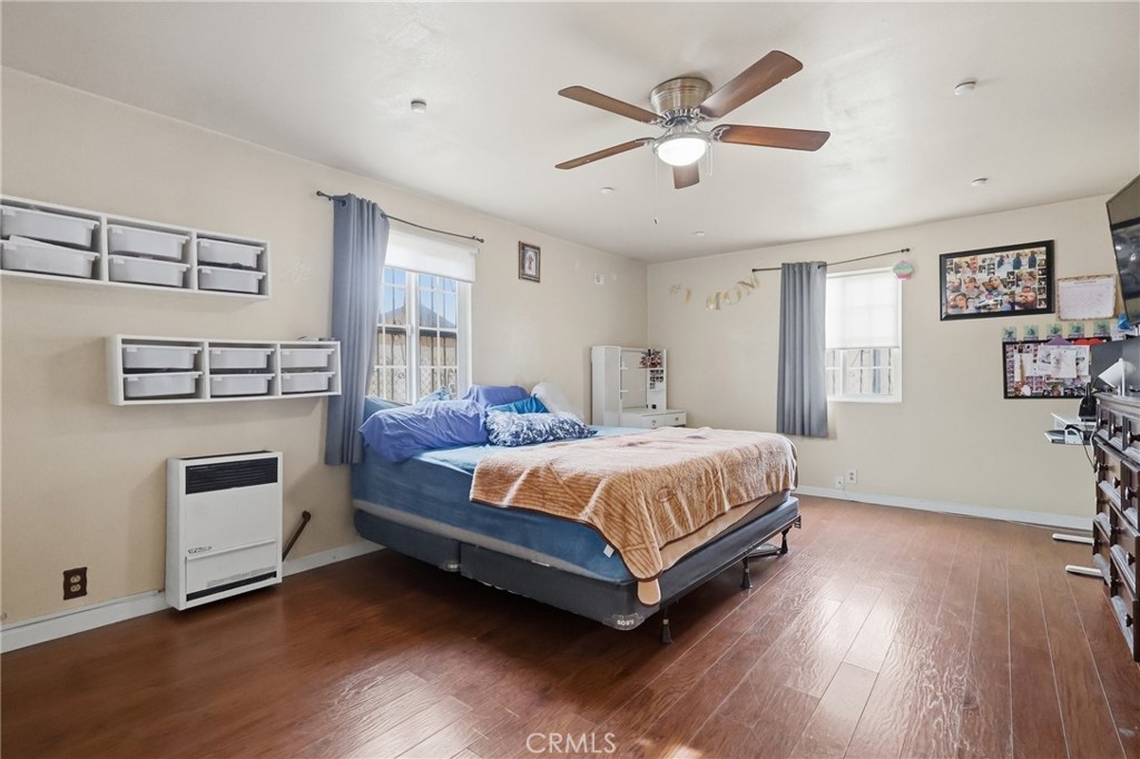 440 West Cherry Street Compton, CA 90222 - Photo 19 of 28 a spacious bedroom with a bed and a ceiling fan