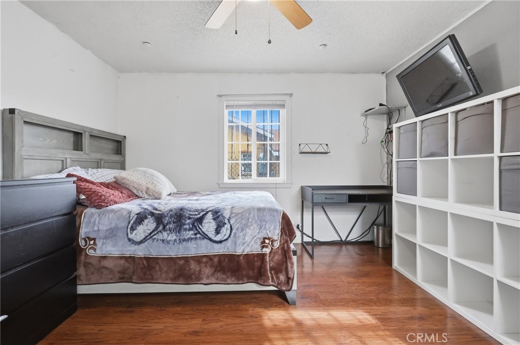 440 West Cherry Street Compton, CA 90222 - Photo 20 of 28 a bedroom with a bed and wooden floor